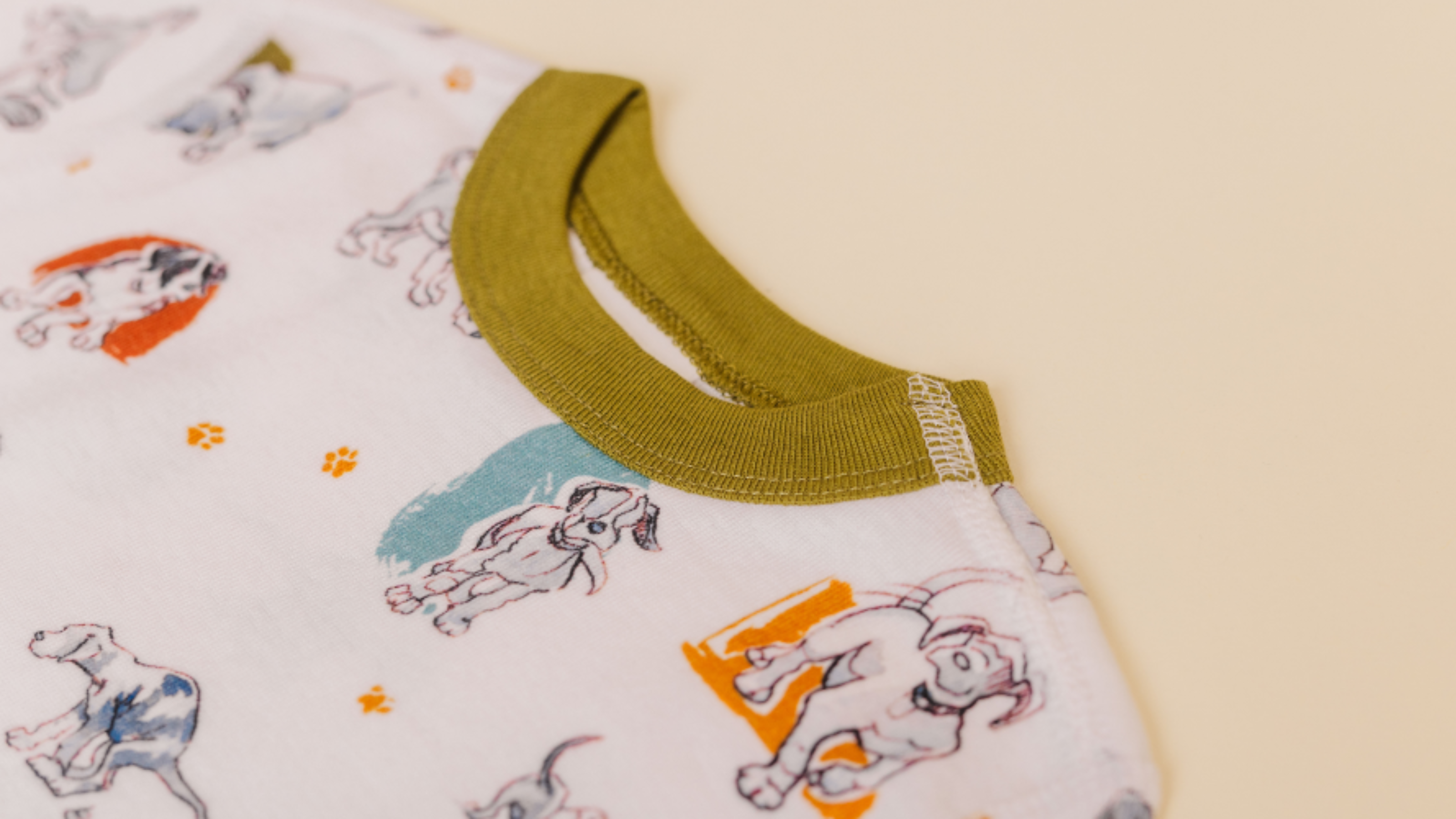 organic cotton pajamas featuring watercolor dog pattern painted by jen sweeney with green accents