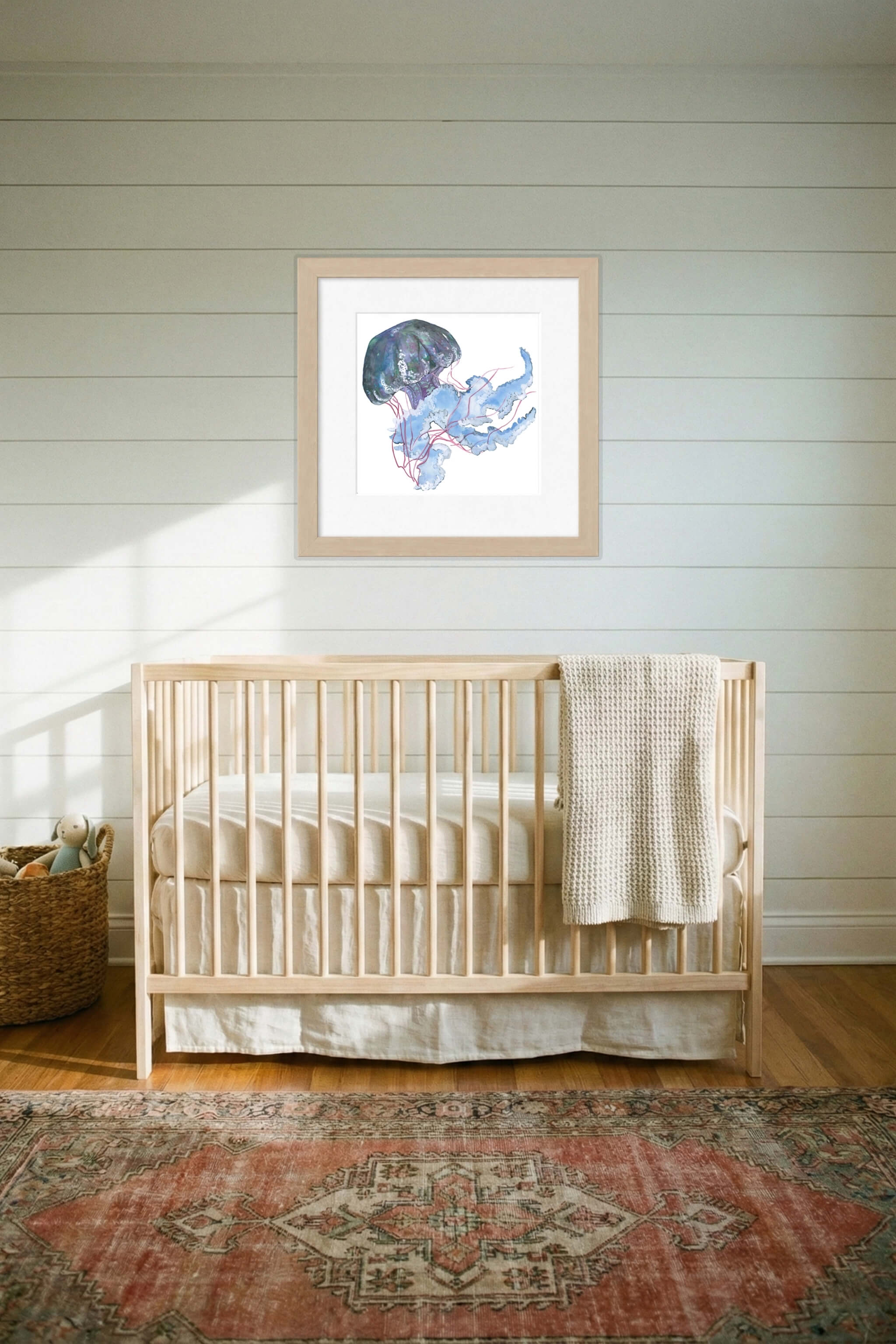 giclee print of watercolor painting of blue jellyfish by emily bourassa above crib