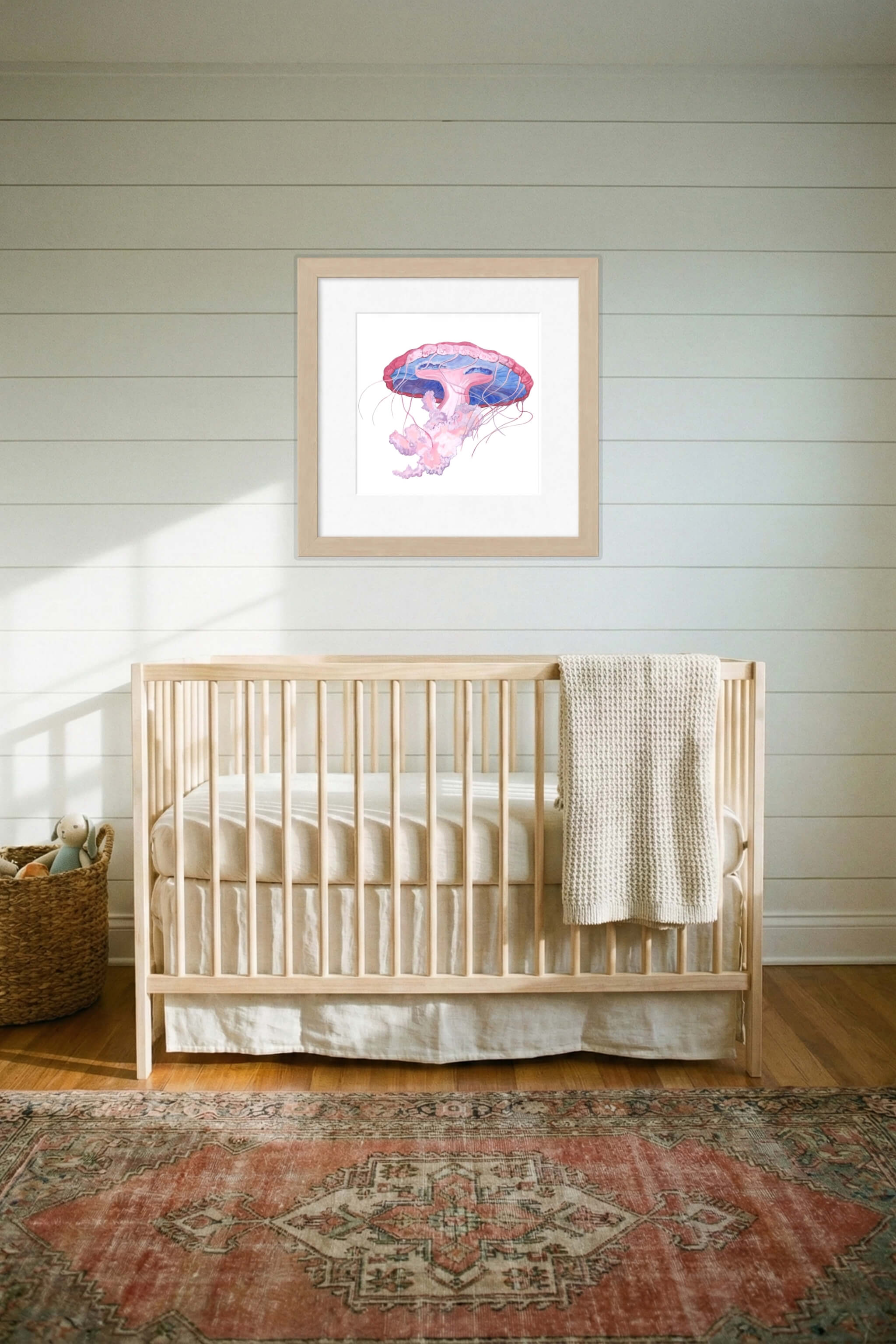 giclee print of watercolor painting of pink jellyfish by emily bourassa above crib