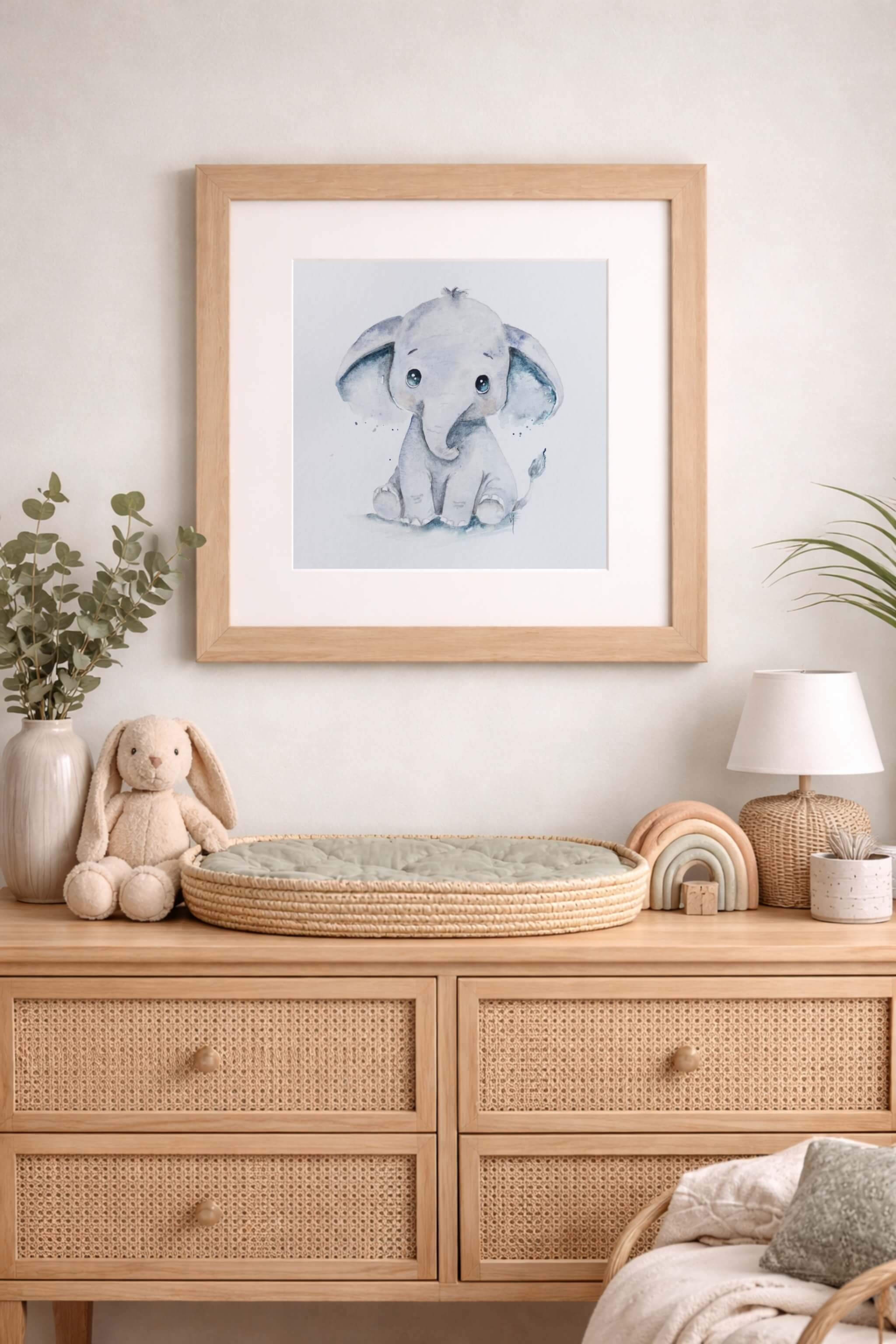 framed watercolor painting above nursery of elephant in blue color tone by lisa naomi in the little trunks of love collection
