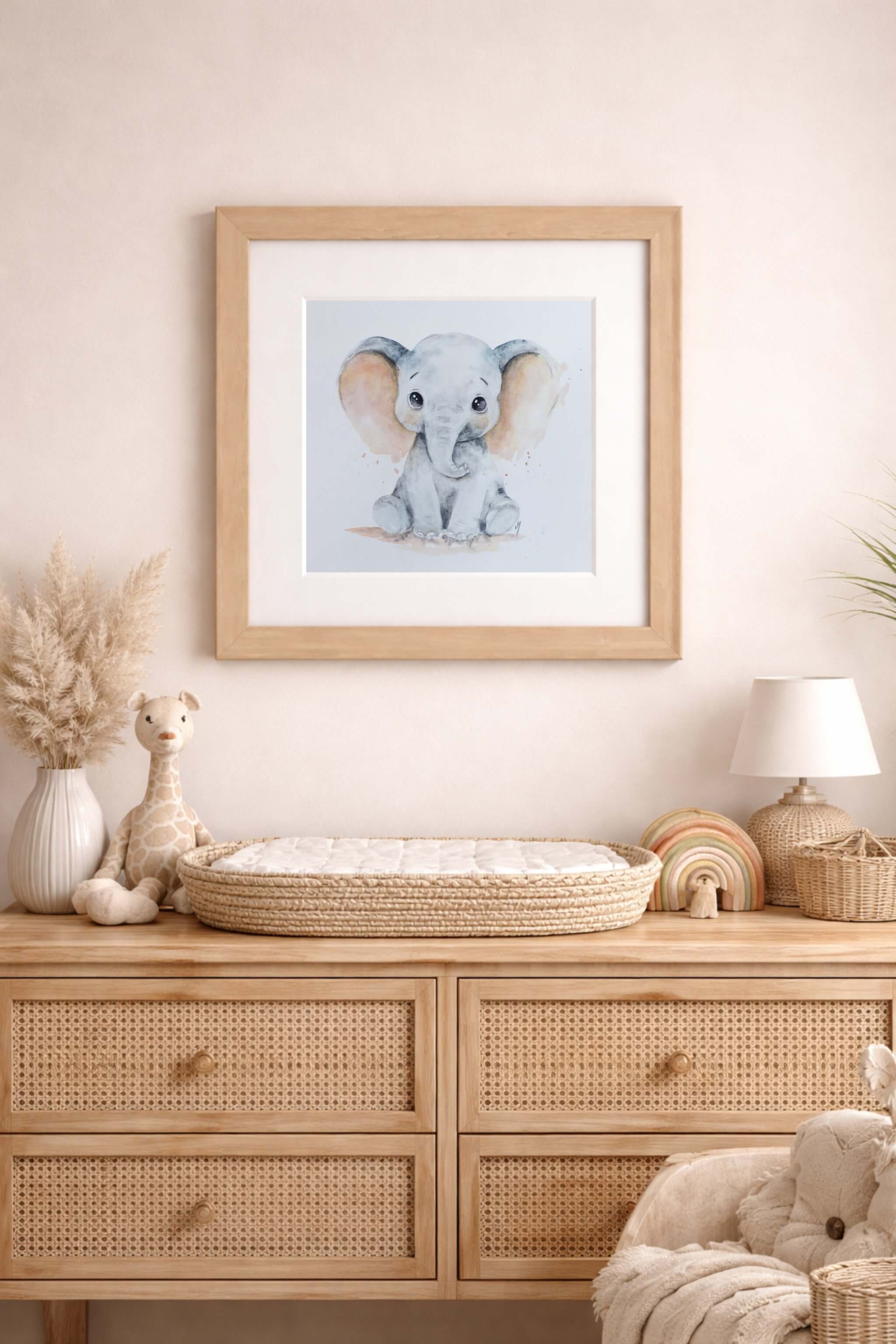 watercolor elephant in frame hanging above nursery in pink color tone by lisa naomi