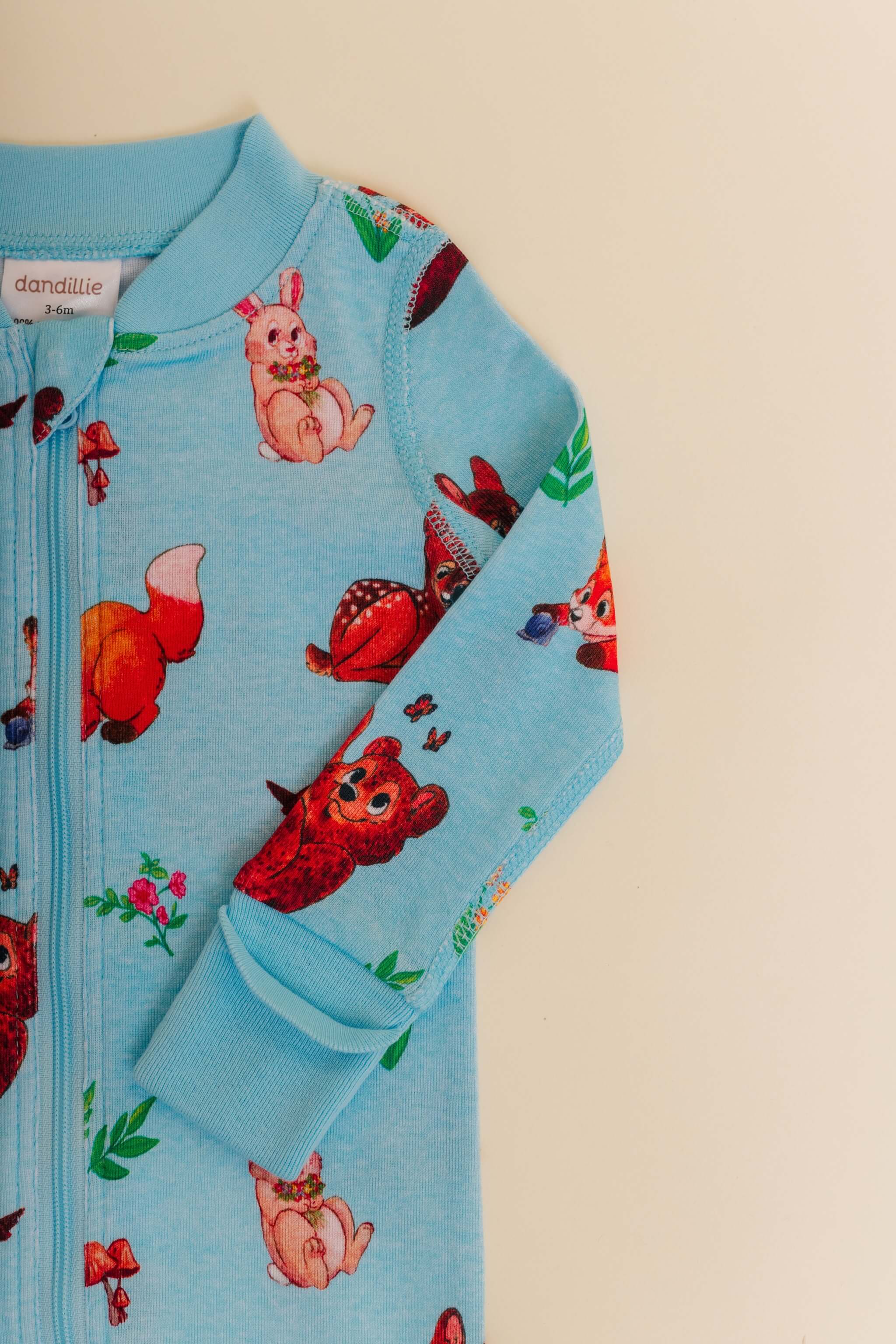 organic cotton baby zipper sleeper with fold-over cuffs in blue animal print designed by anna iwin