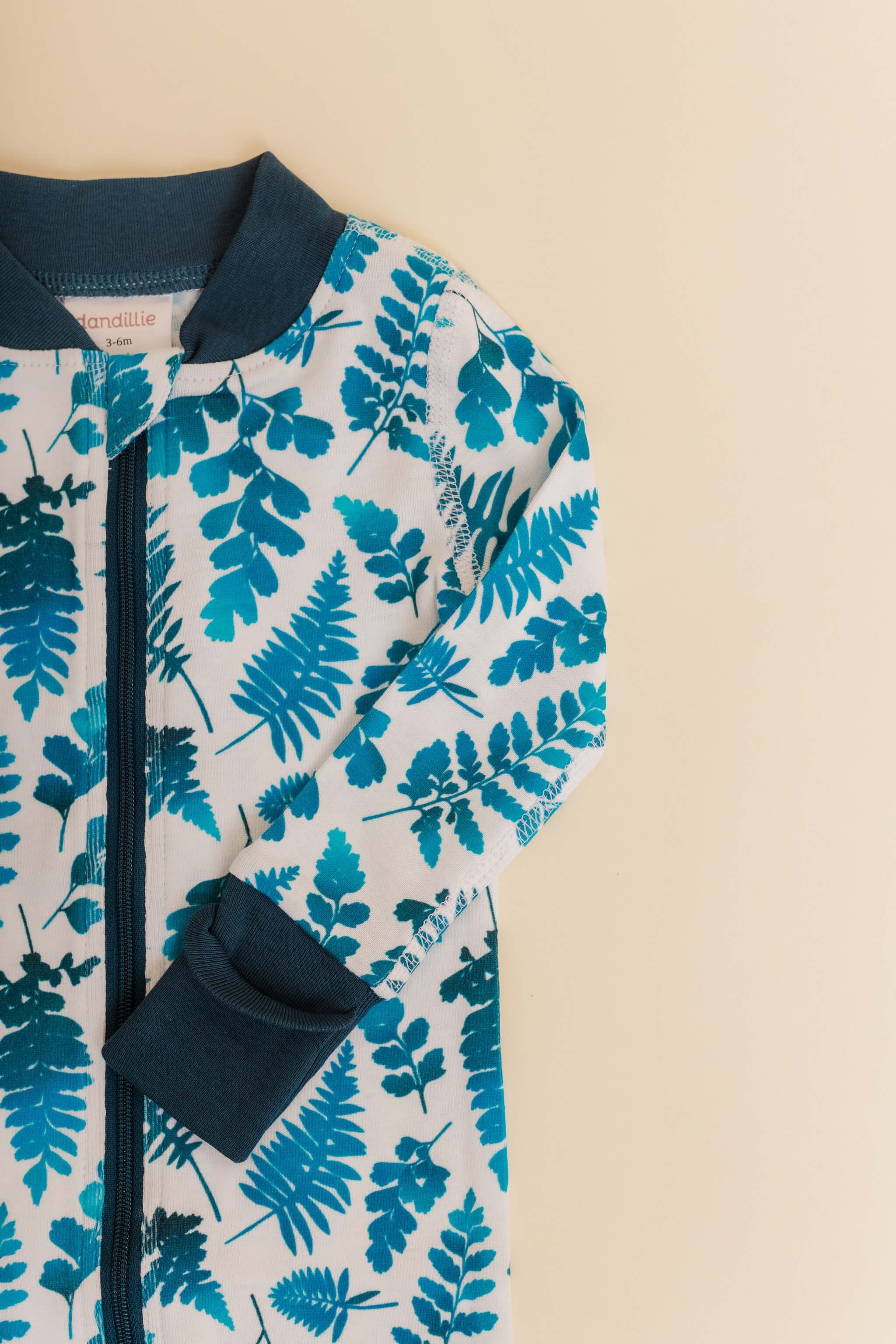 organic cotton baby zipper sleeper with fold-over cuffs in blue fern print designed by jen johnston
