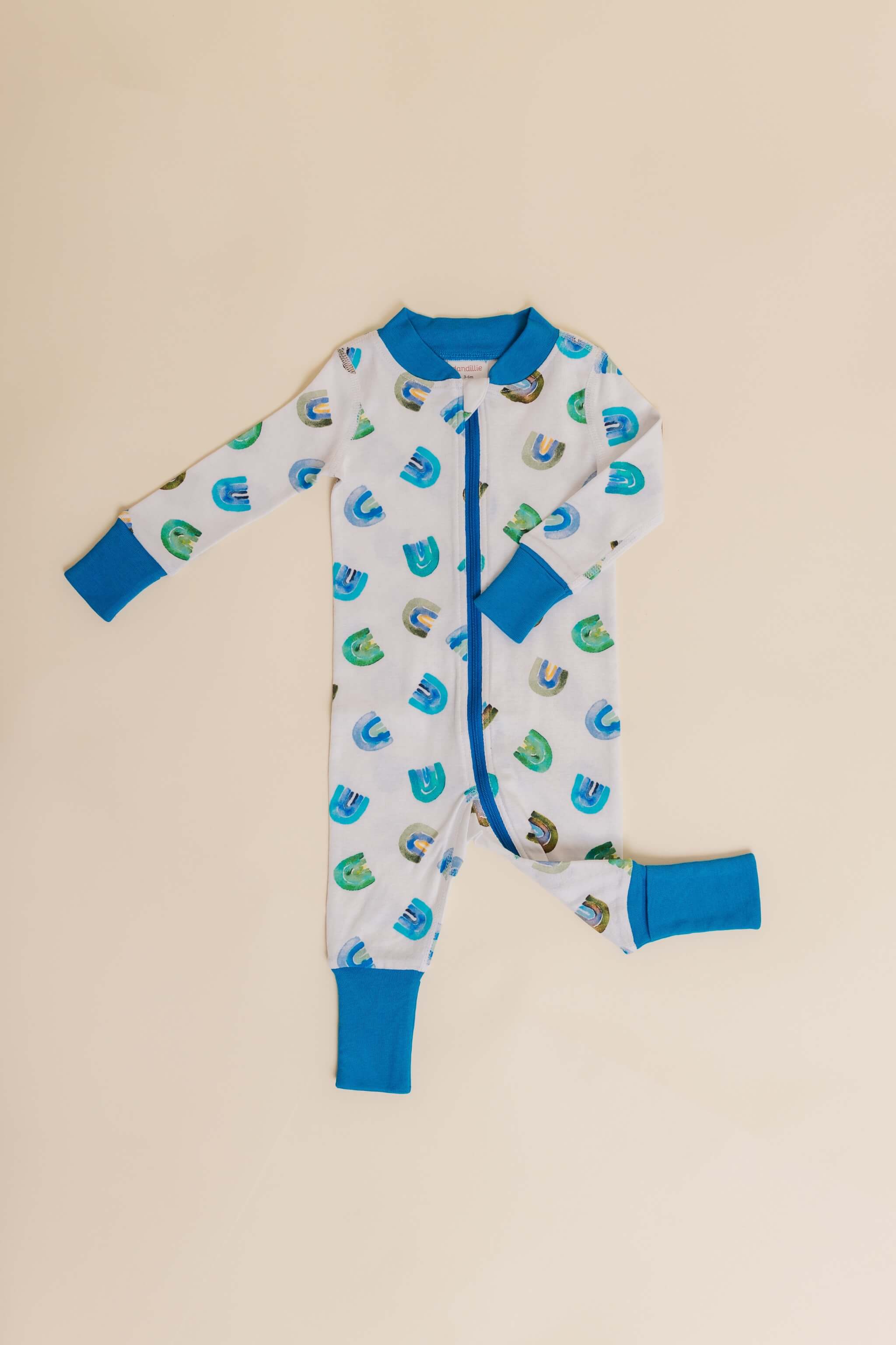 organic cotton baby zipper sleeper with fold-over cuffs in blue rainbow print designed by madeline kerrii