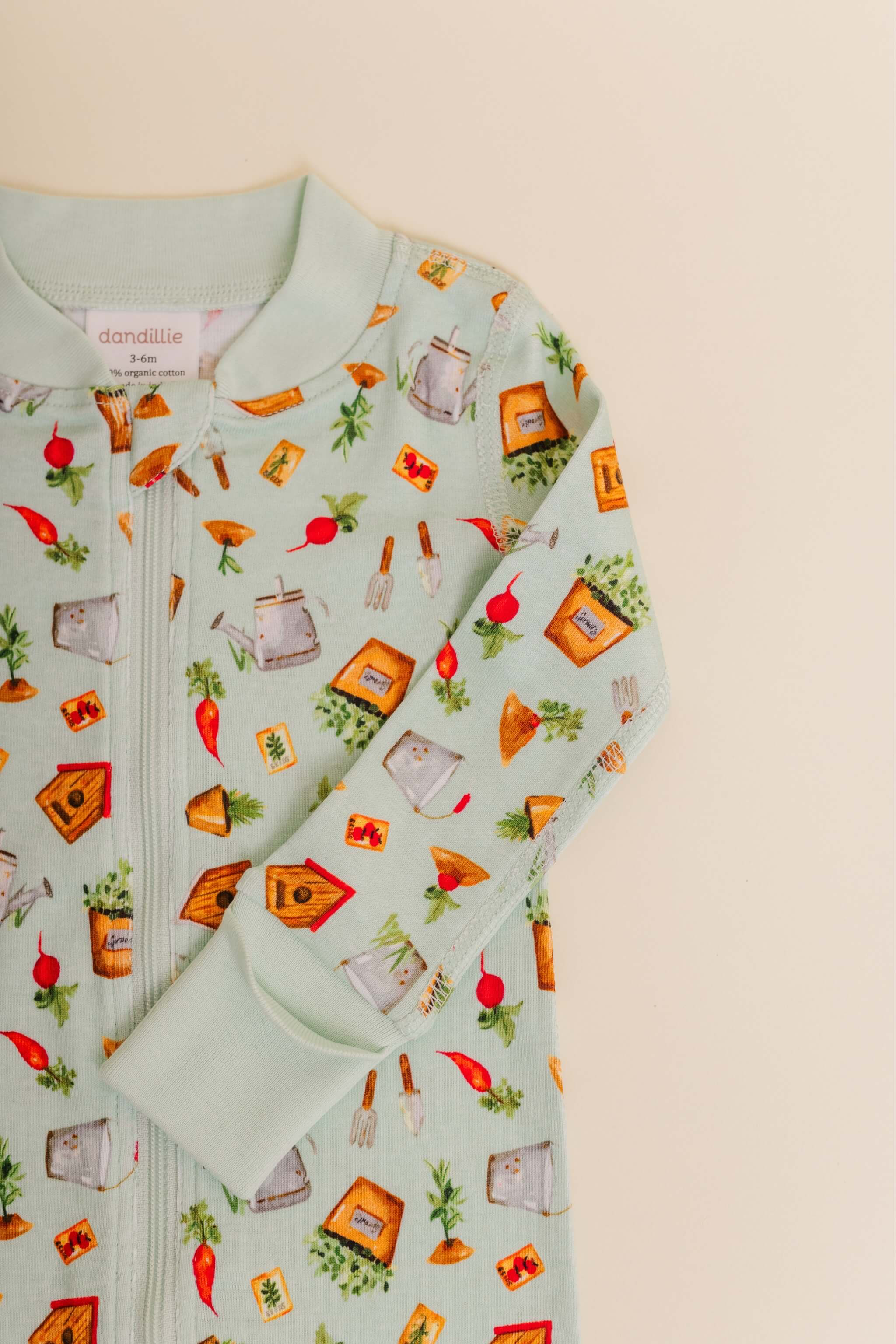 organic cotton baby zipper sleeper with fold-over cuffs in green garden print designed by cris rogerson