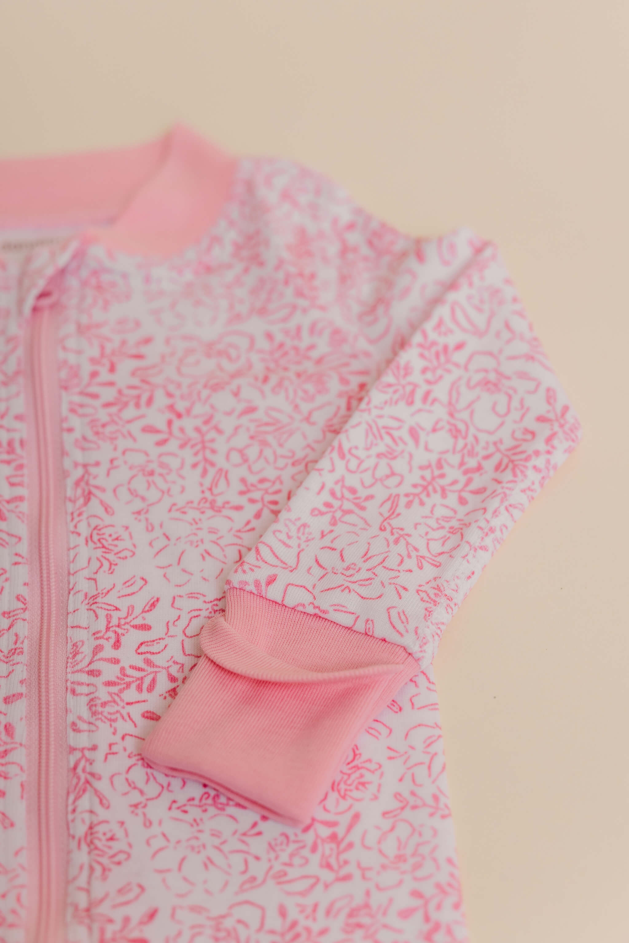 organic cotton baby zipper sleeper with fold-over cuffs in pink floral print designed by eliza baucom