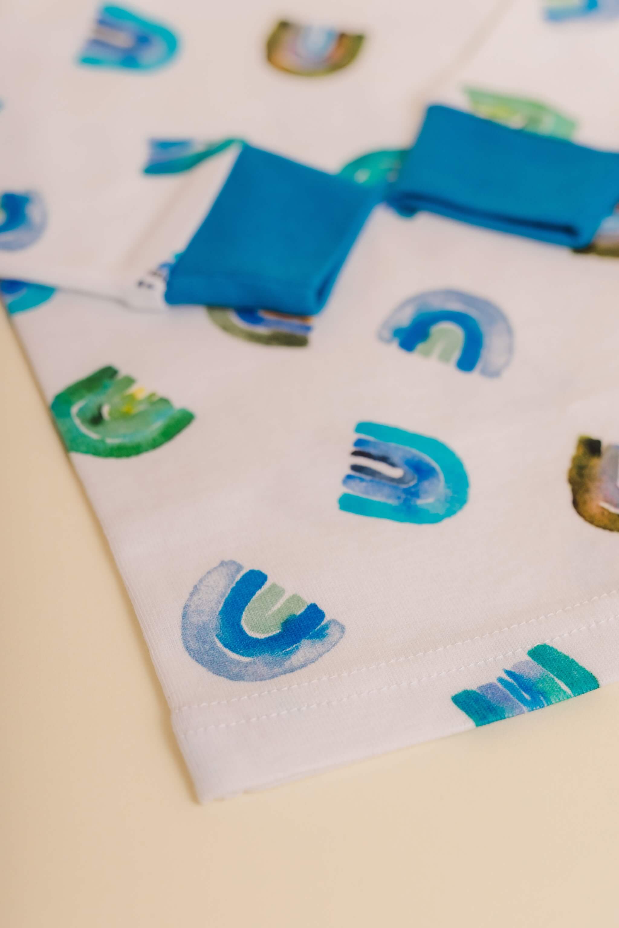 organic cotton children's long sleeve sleepwear in blue rainbow print designed by madeline kerrii