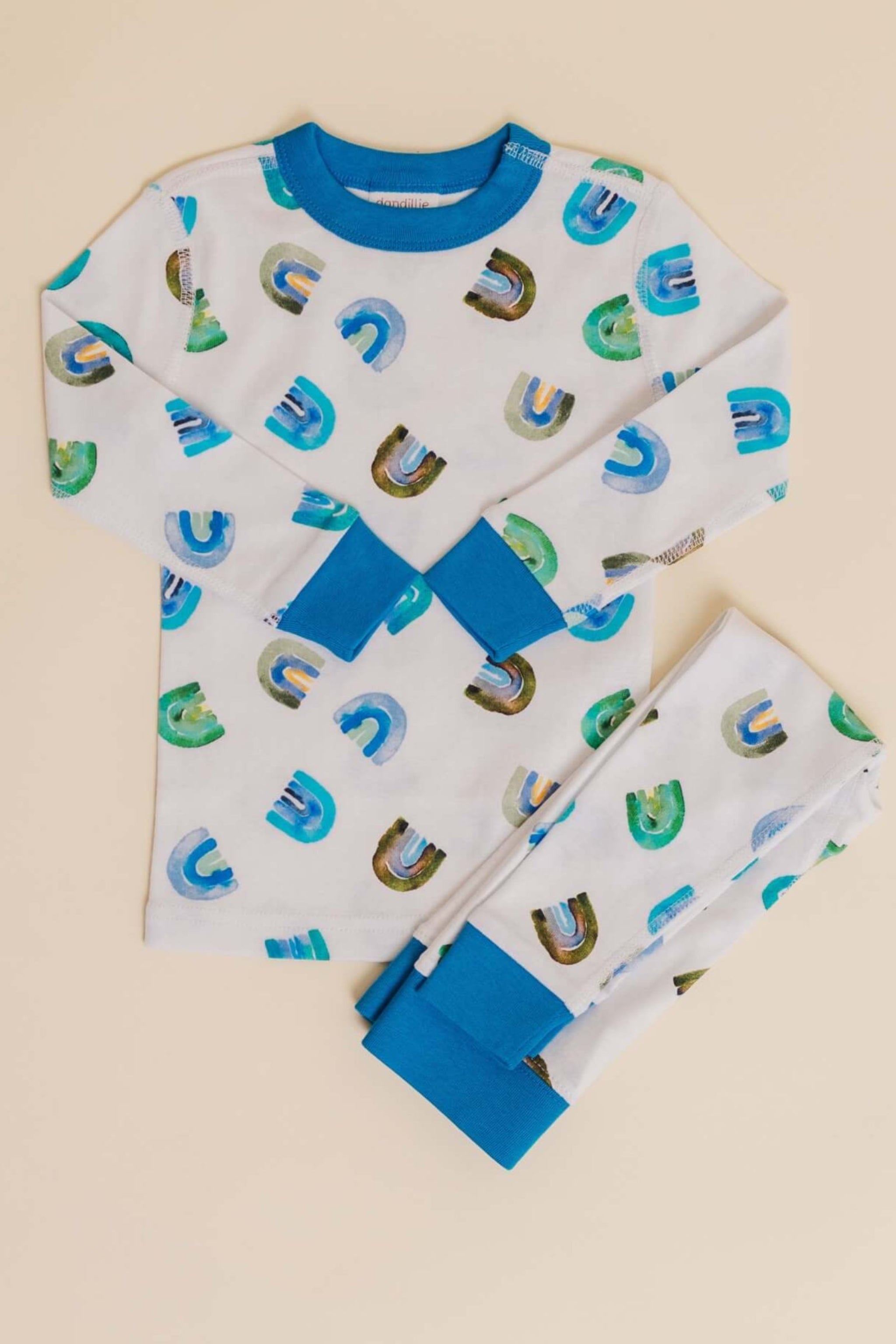 organic cotton children's long sleeve sleepwear in blue rainbow print designed by madeline kerrii