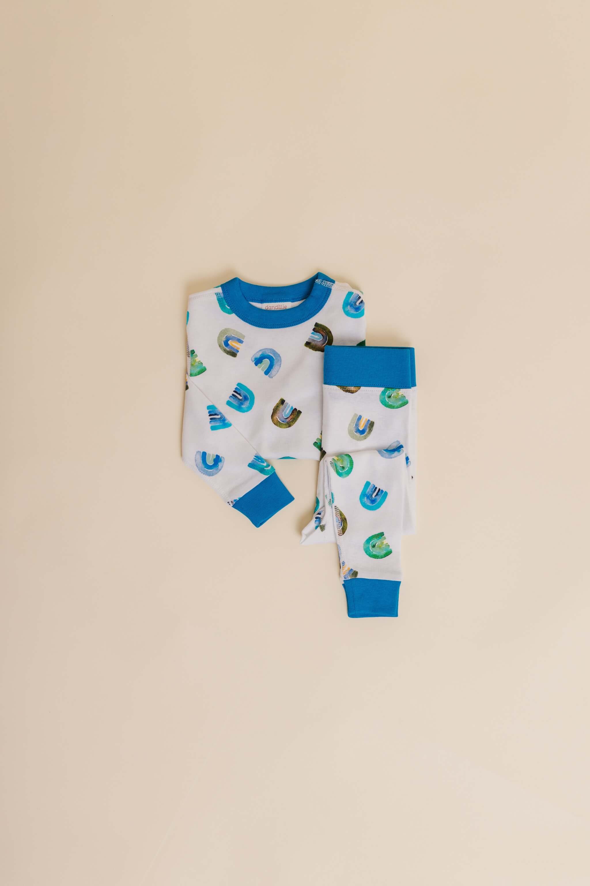 organic cotton children's long sleeve sleepwear in blue rainbow print designed by madeline kerrii
