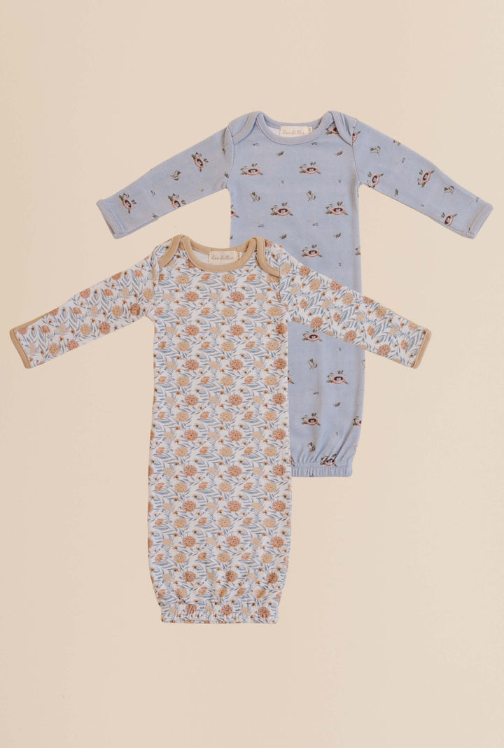 Two baby onesies with floral and bird prints on a beige background