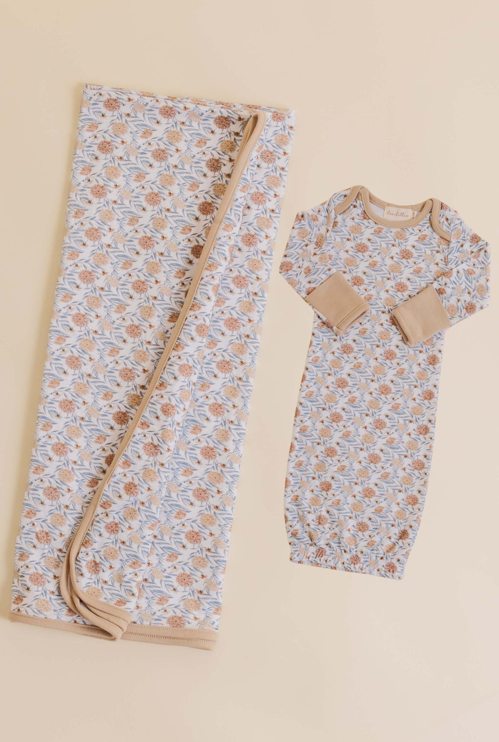 Baby wrap and onesie with floral pattern on a beige background