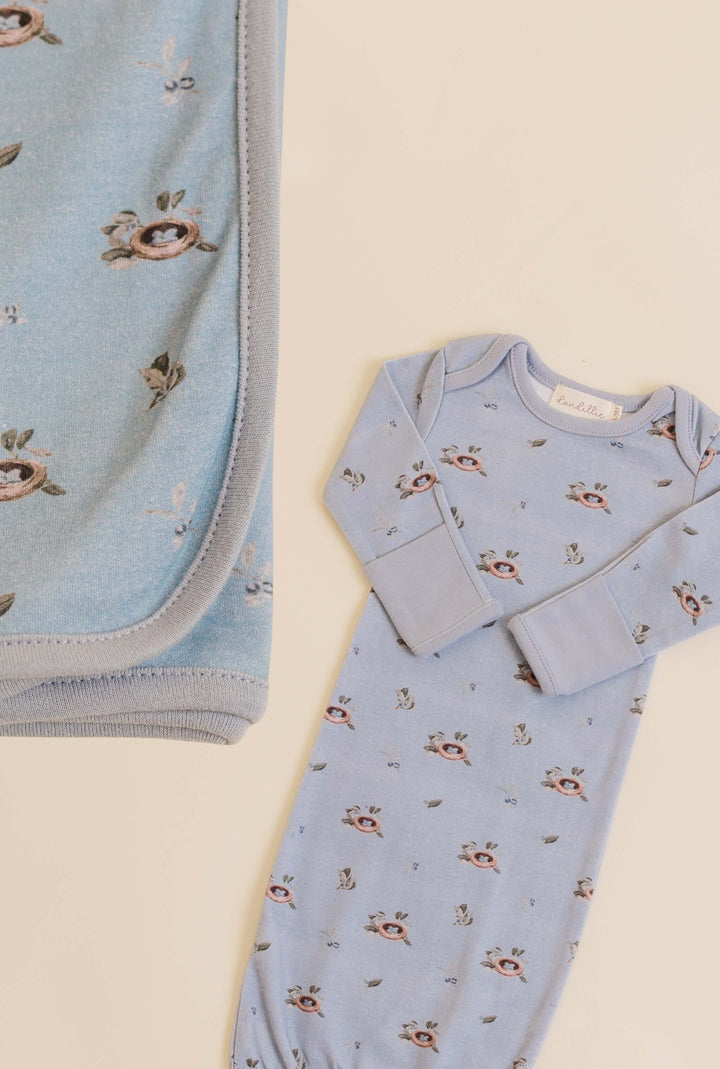 Baby outfit with bird pattern on a light background