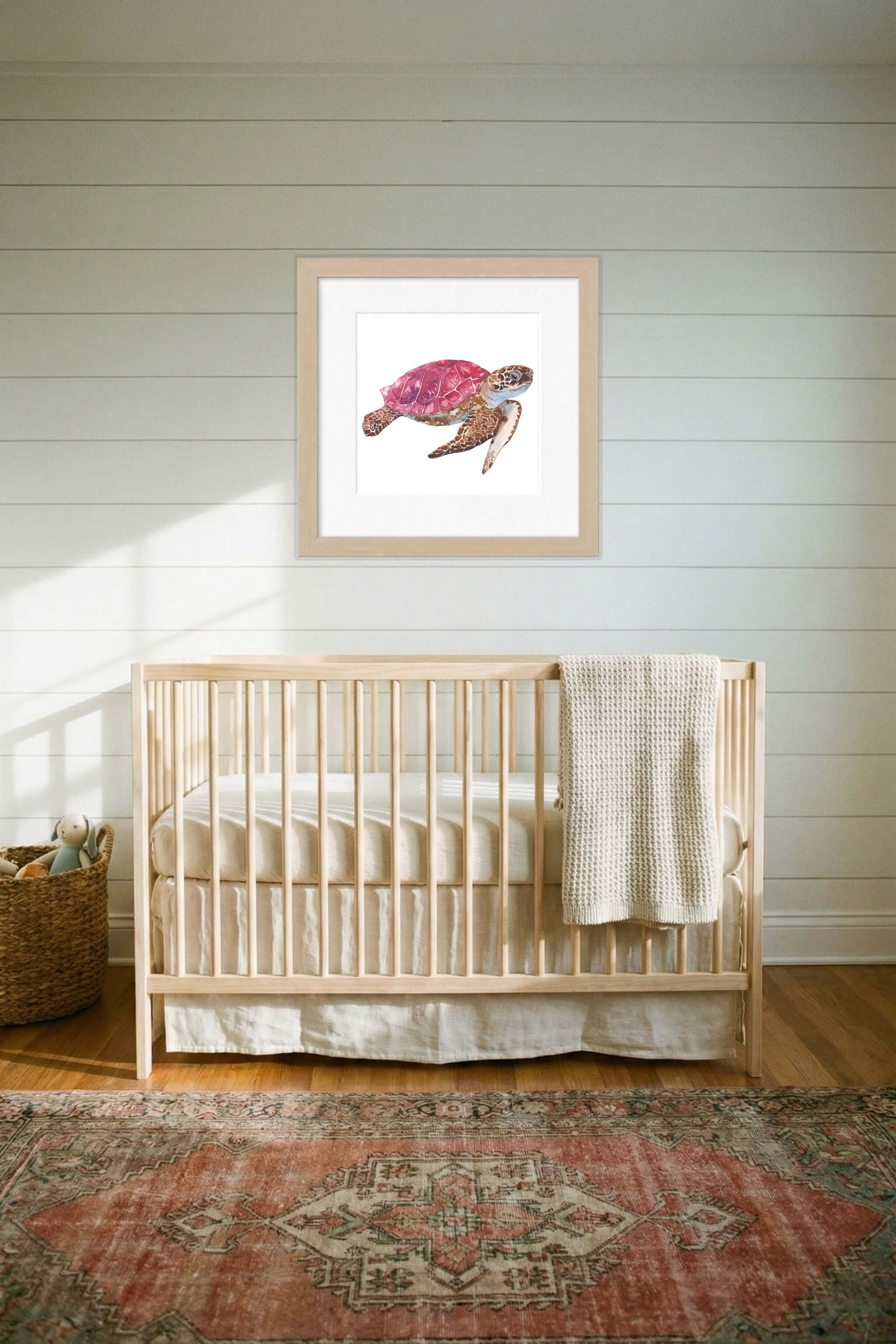 giclee print of watercolor painting of pink sea turtle by emily bourassa above crib
