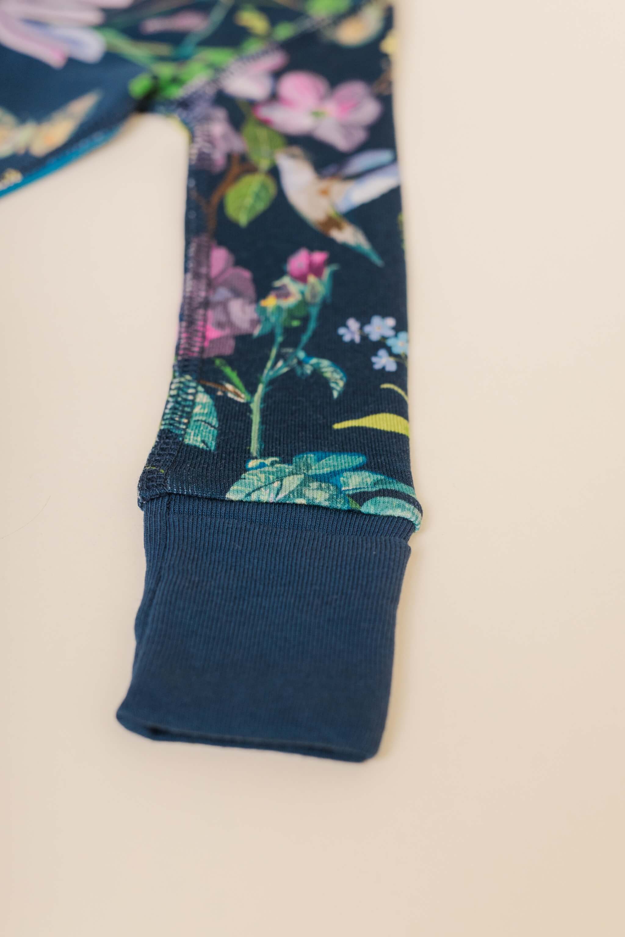organic cotton baby zipper sleeper with fold-over cuffs in blue floral print designed by julia whitney barnes