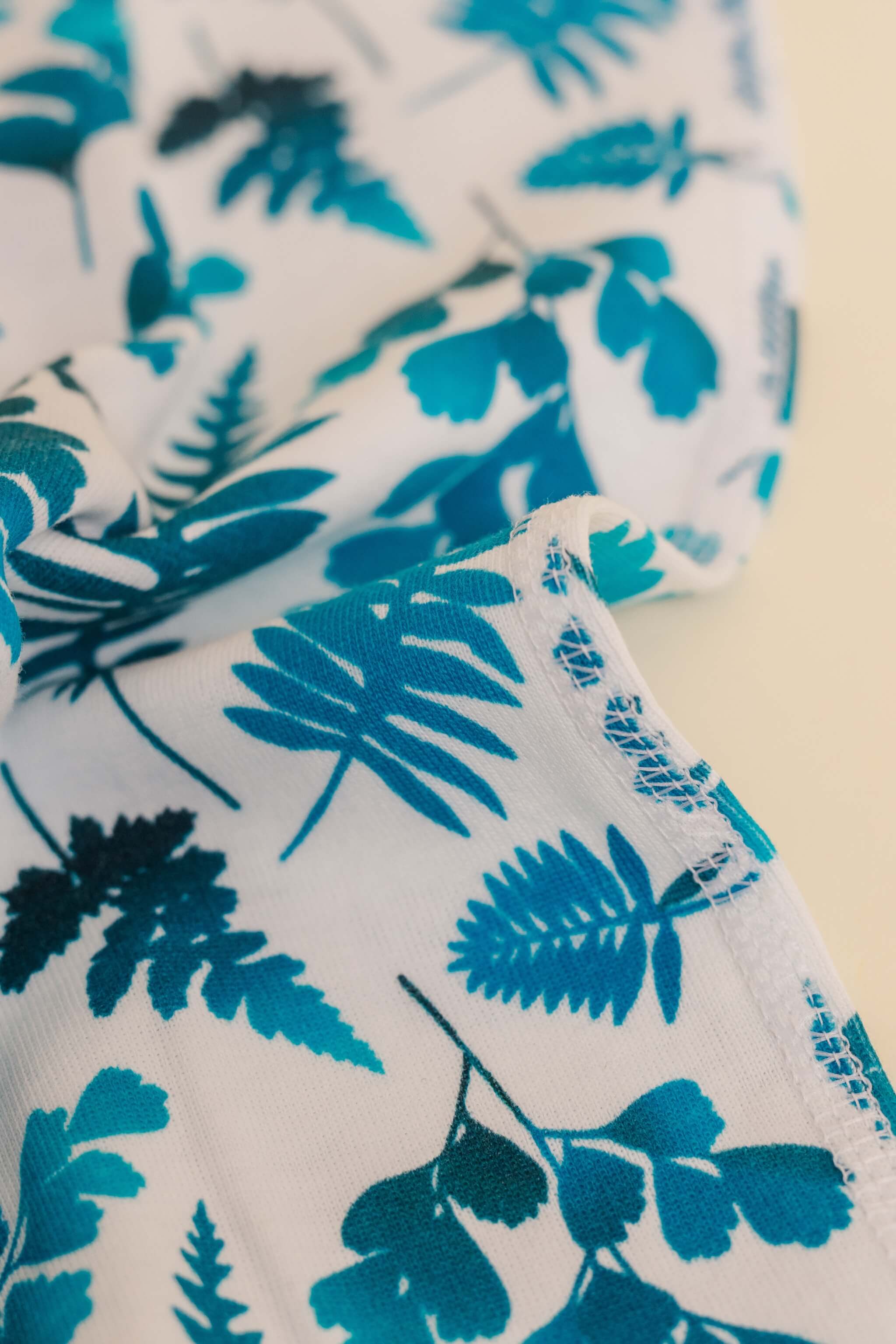 organic cotton baby zipper sleeper with fold-over cuffs in blue fern print designed by jen johnston