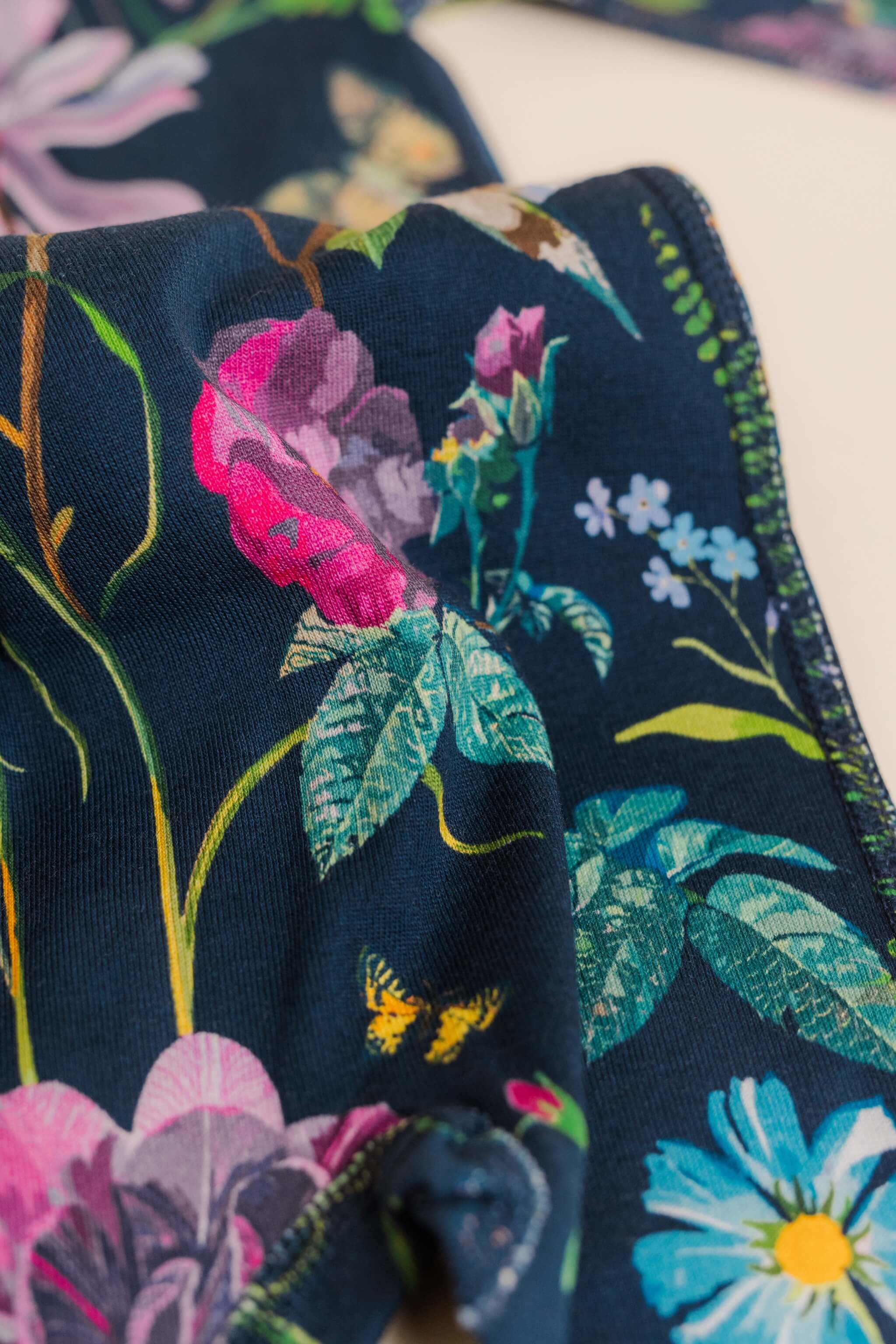 organic cotton baby zipper sleeper with fold-over cuffs in blue floral print designed by julia whitney barnes