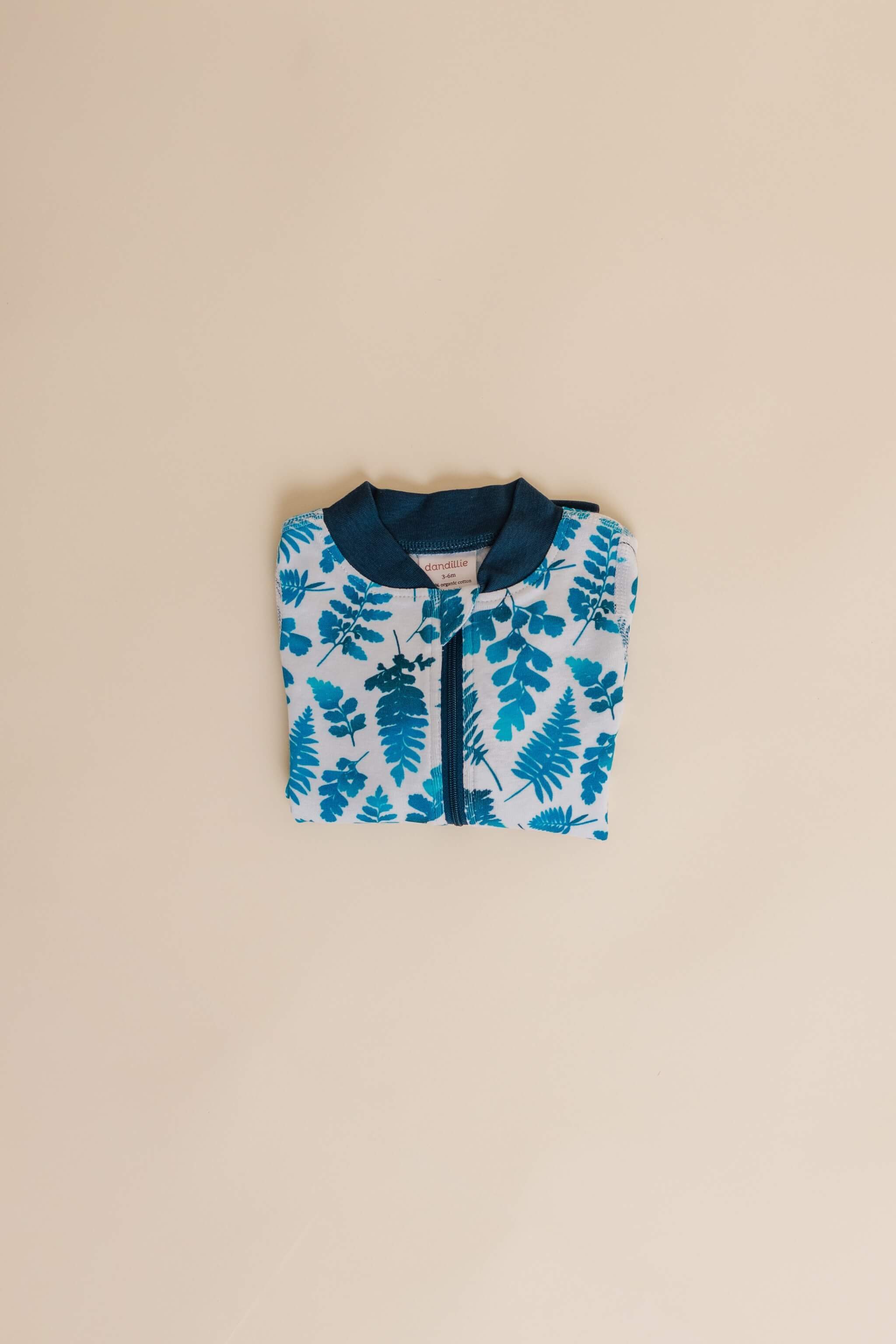 organic cotton baby zipper sleeper with fold-over cuffs in blue fern print designed by jen johnston