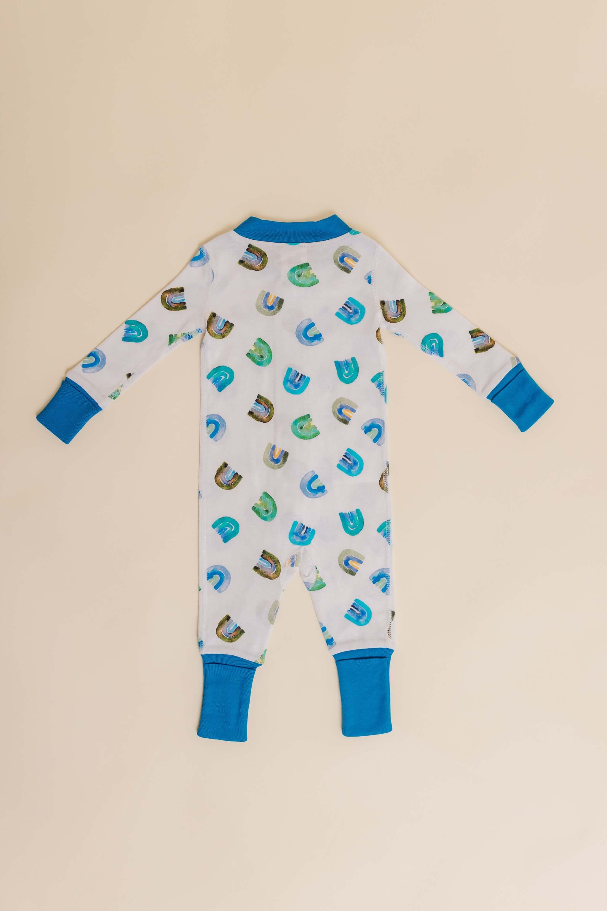 organic cotton baby zipper sleeper with fold-over cuffs in blue rainbow print designed by madeline kerrii