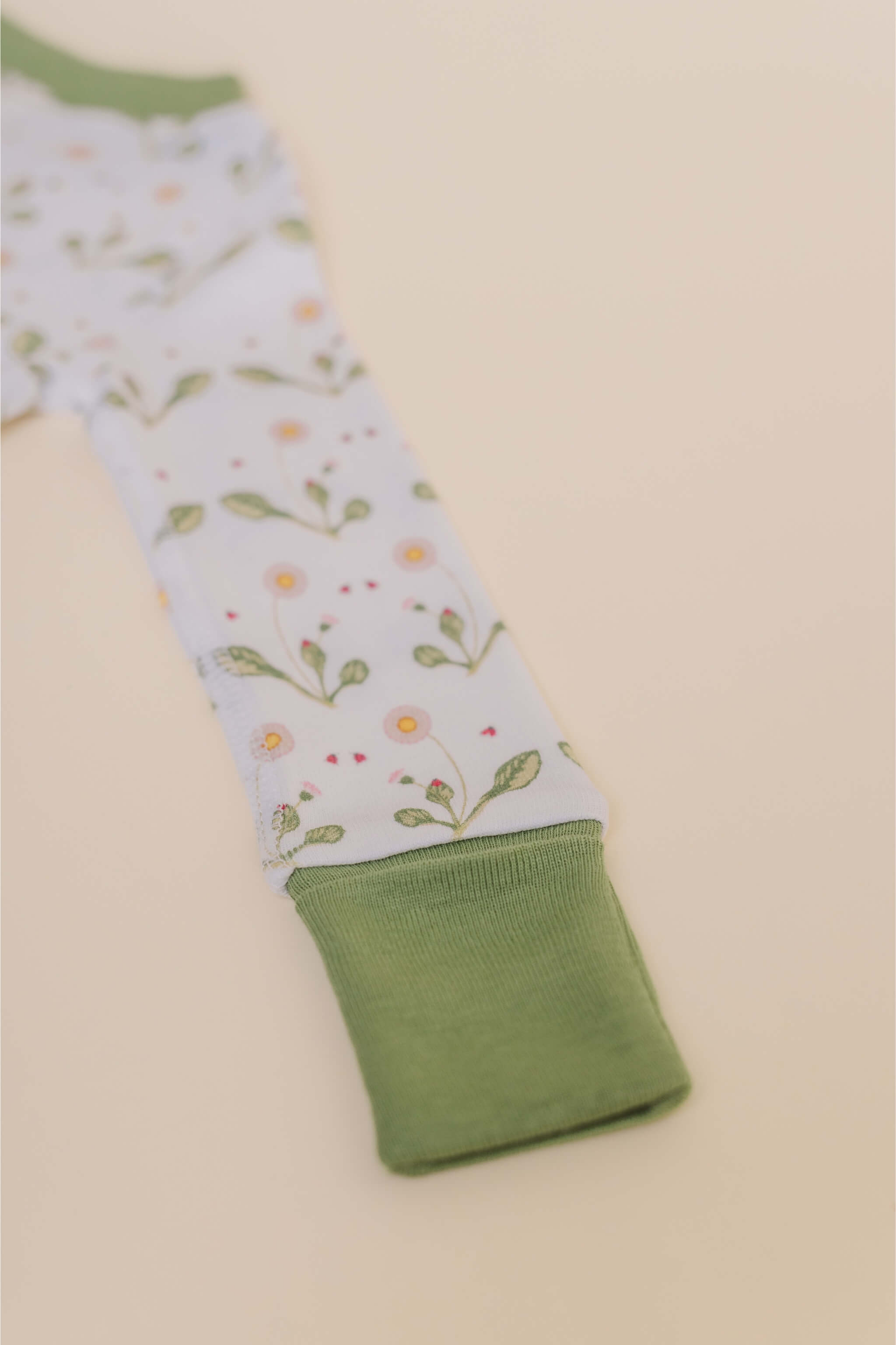organic cotton baby zipper sleeper with fold-over cuffs in green daisy print designed by giacomina ferrillo