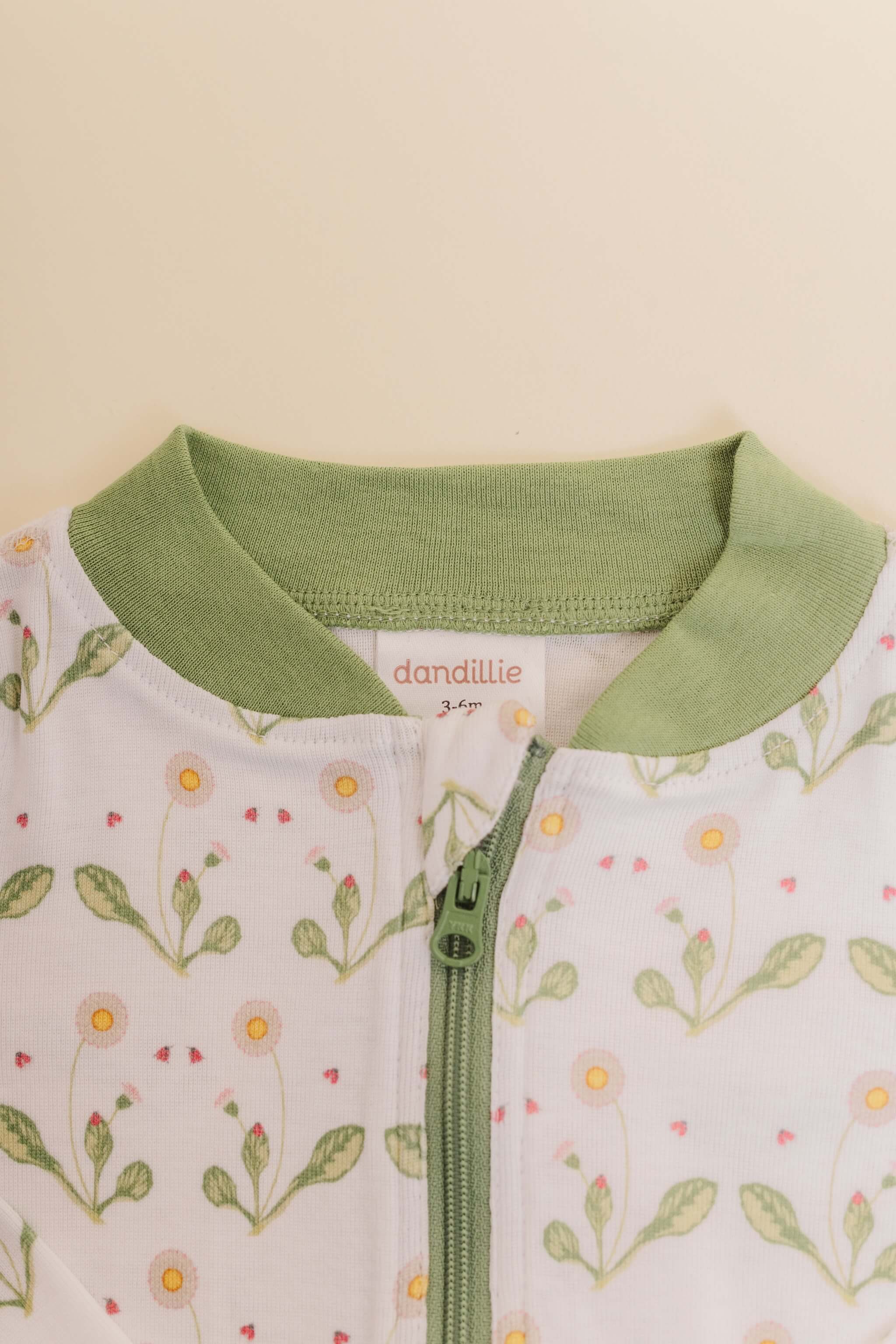organic cotton baby zipper sleeper with fold-over cuffs in green daisy print designed by giacomina ferrillo