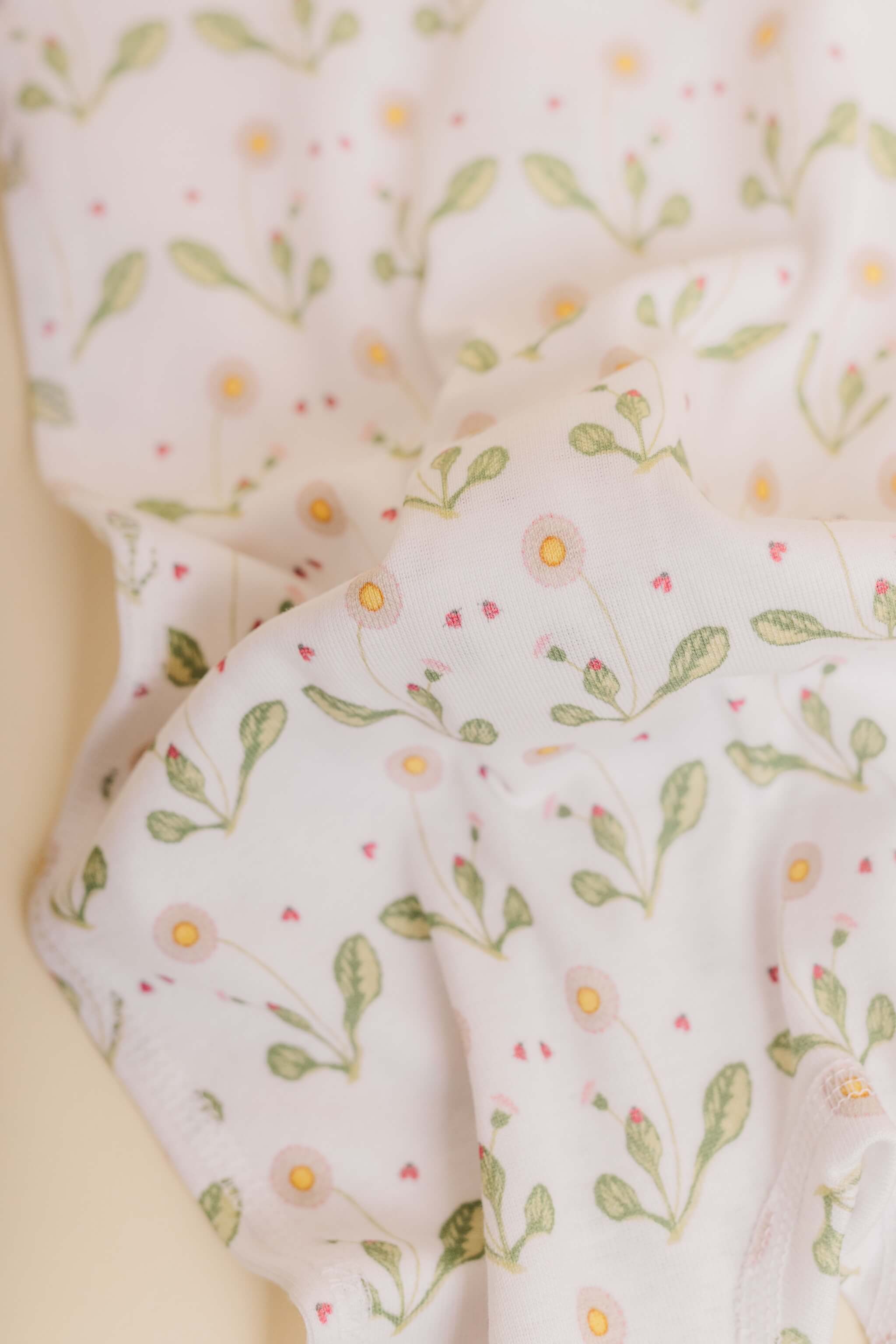 organic cotton baby zipper sleeper with fold-over cuffs in green daisy print designed by giacomina ferrillo