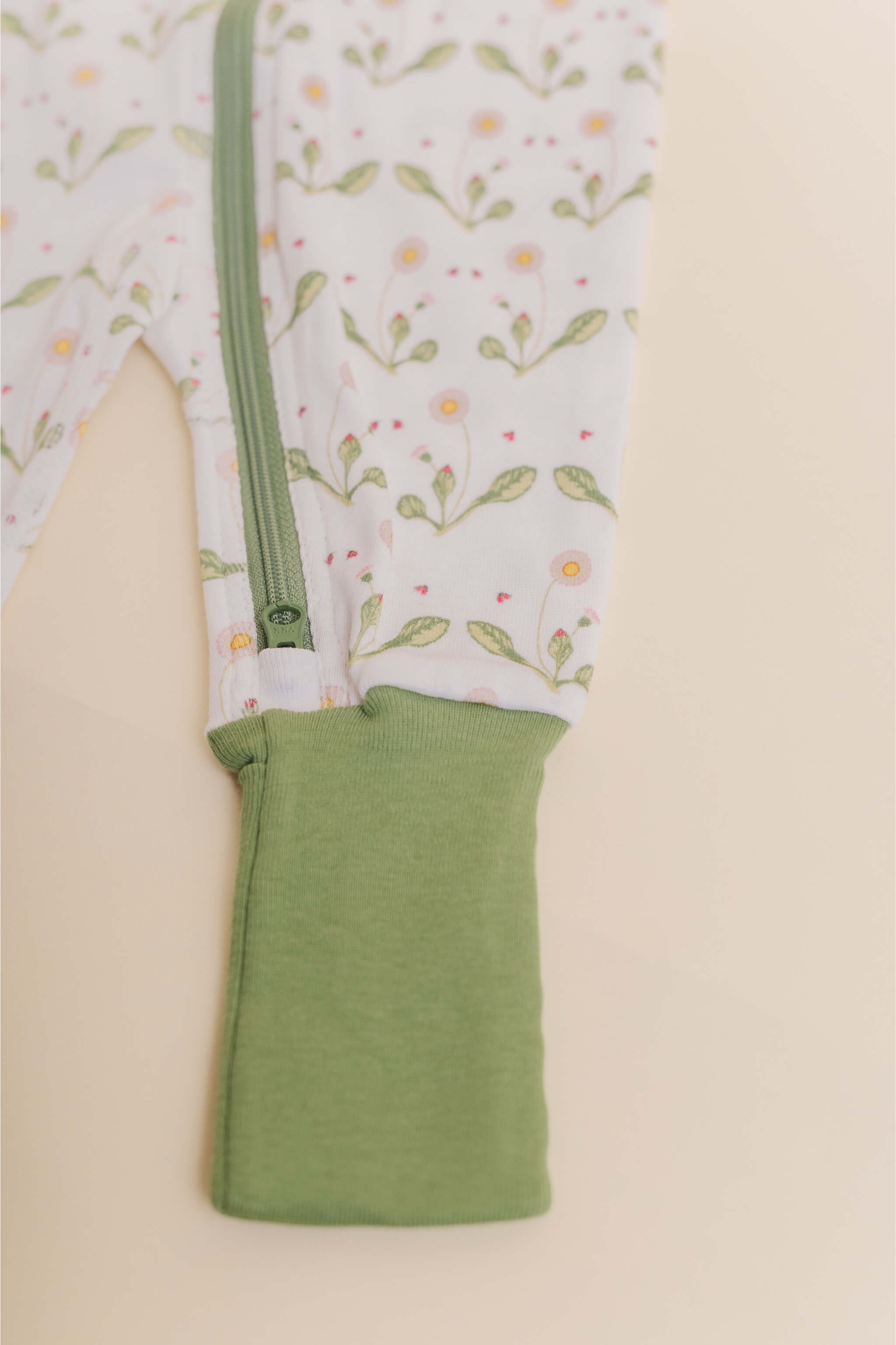 organic cotton baby zipper sleeper with fold-over cuffs in green daisy print designed by giacomina ferrillo