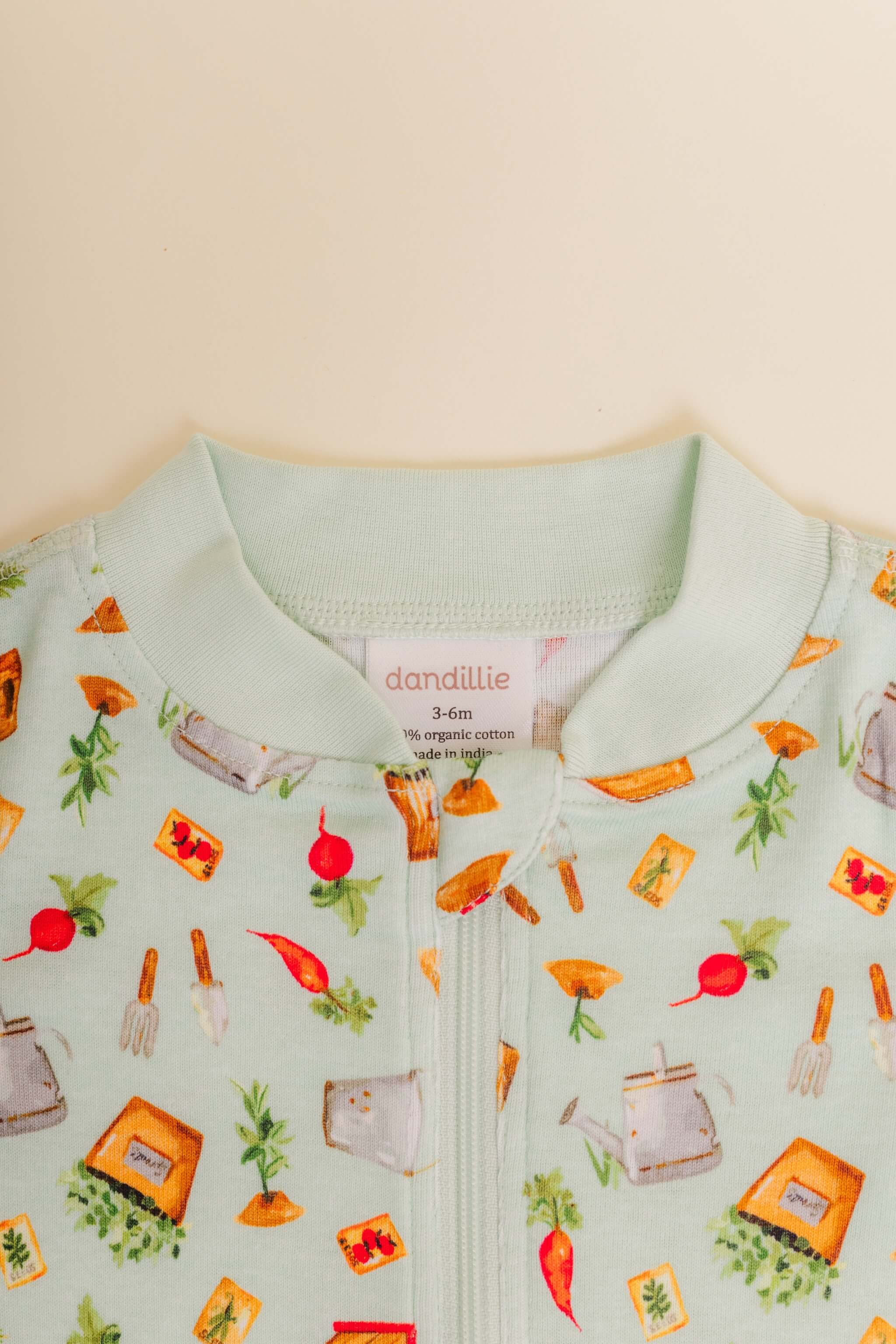 organic cotton baby zipper sleeper with fold-over cuffs in green garden print designed by cris rogerson