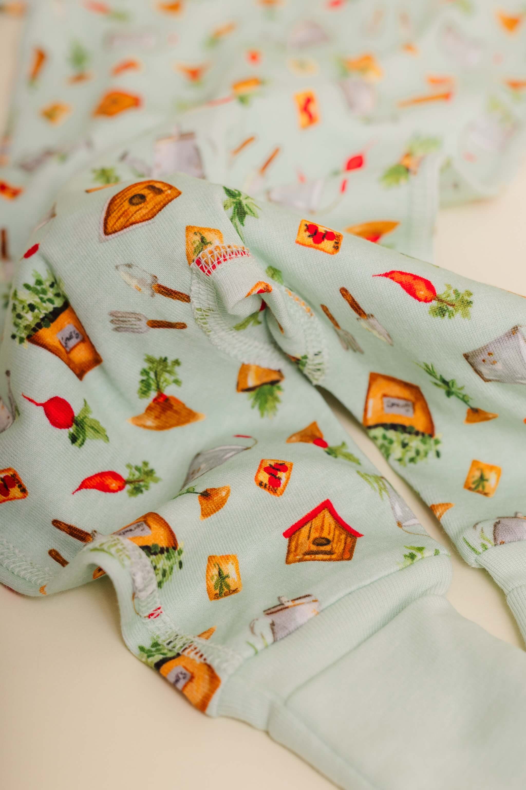 organic cotton baby zipper sleeper with fold-over cuffs in green garden print designed by cris rogerson