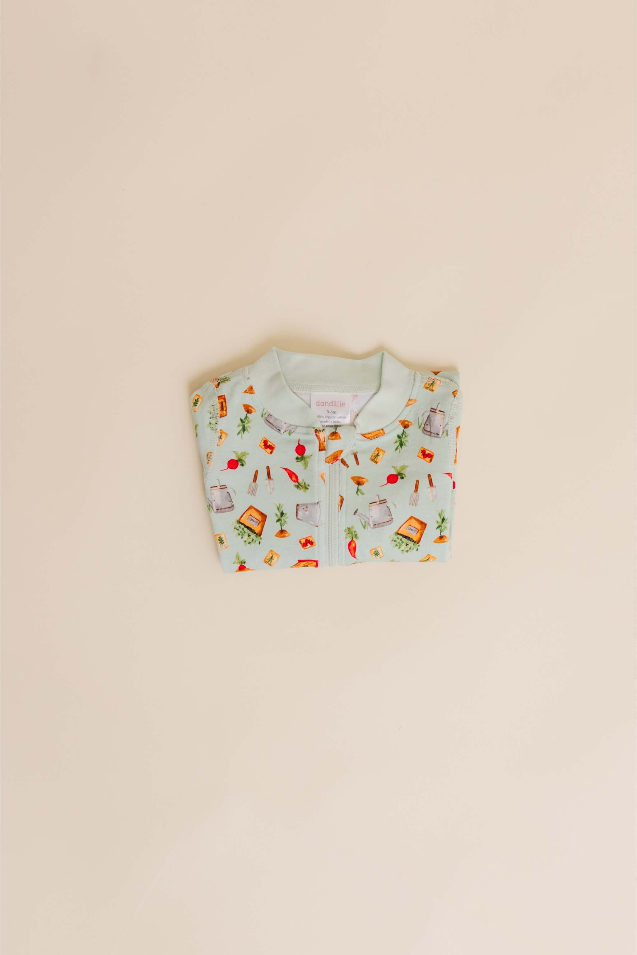 organic cotton baby zipper sleeper with fold-over cuffs in green garden print designed by cris rogerson