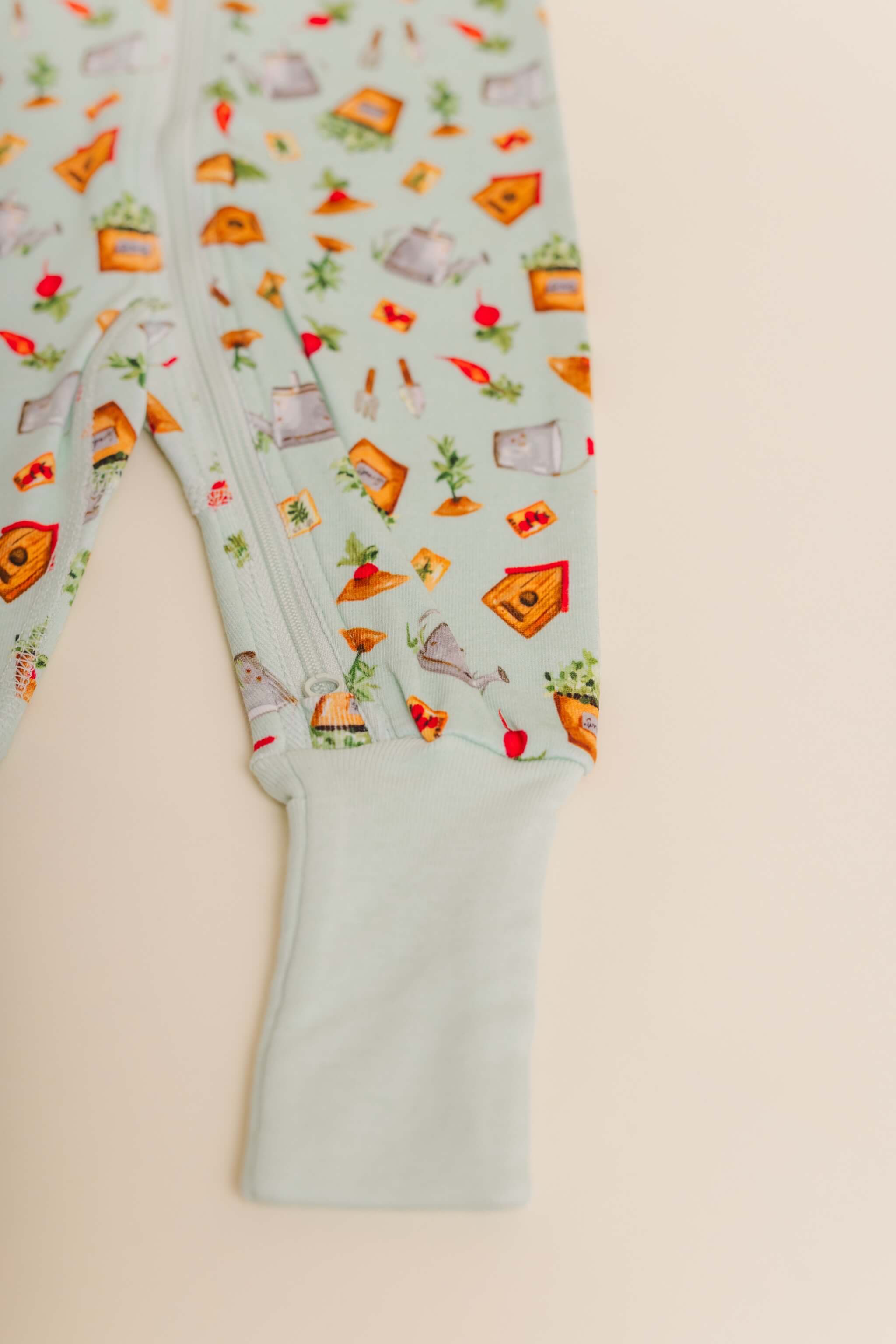 organic cotton baby zipper sleeper with fold-over cuffs in green garden print designed by cris rogerson