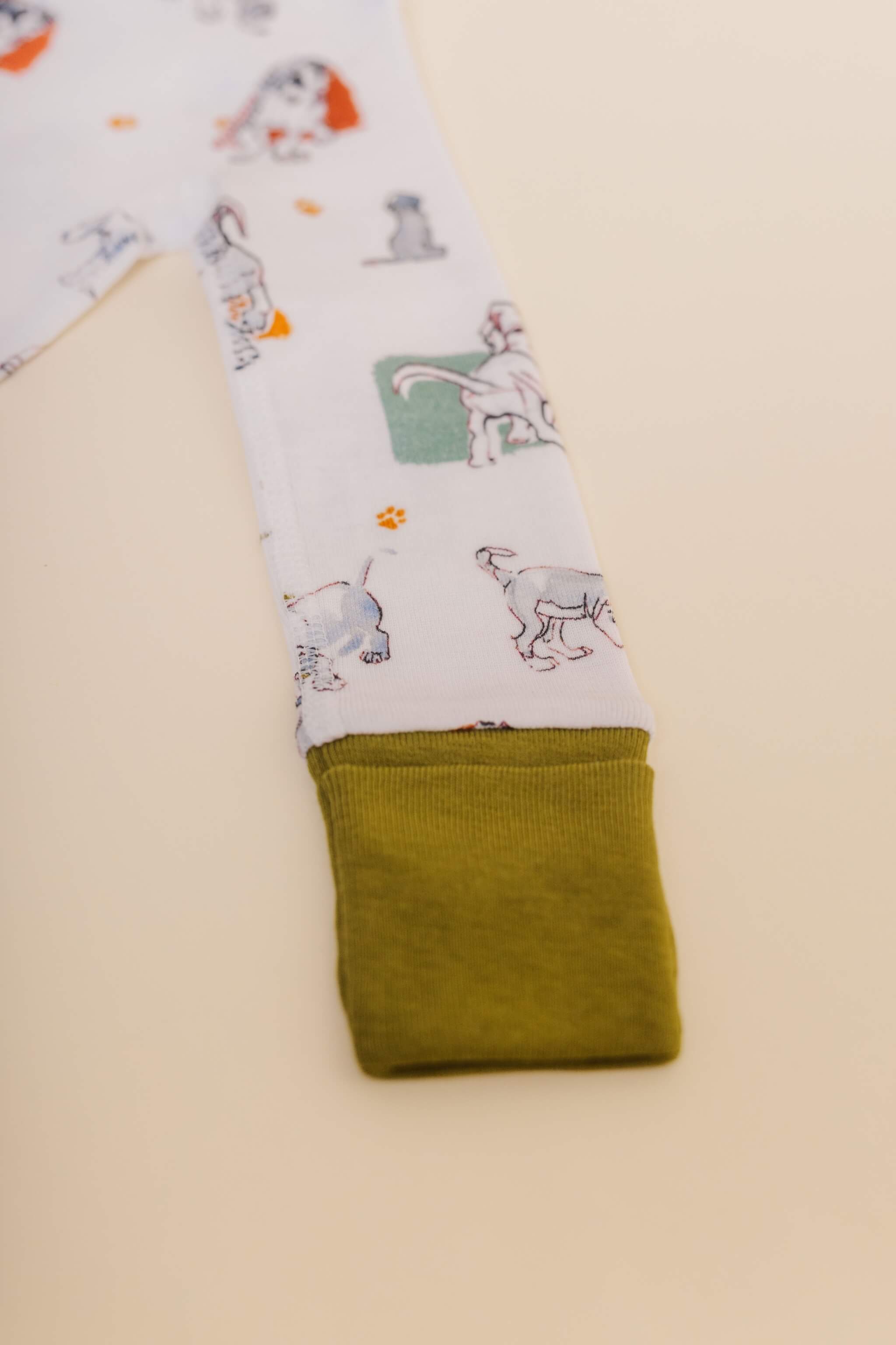organic cotton baby zipper sleeper with fold-over cuffs in green puppy print designed by jen brandon