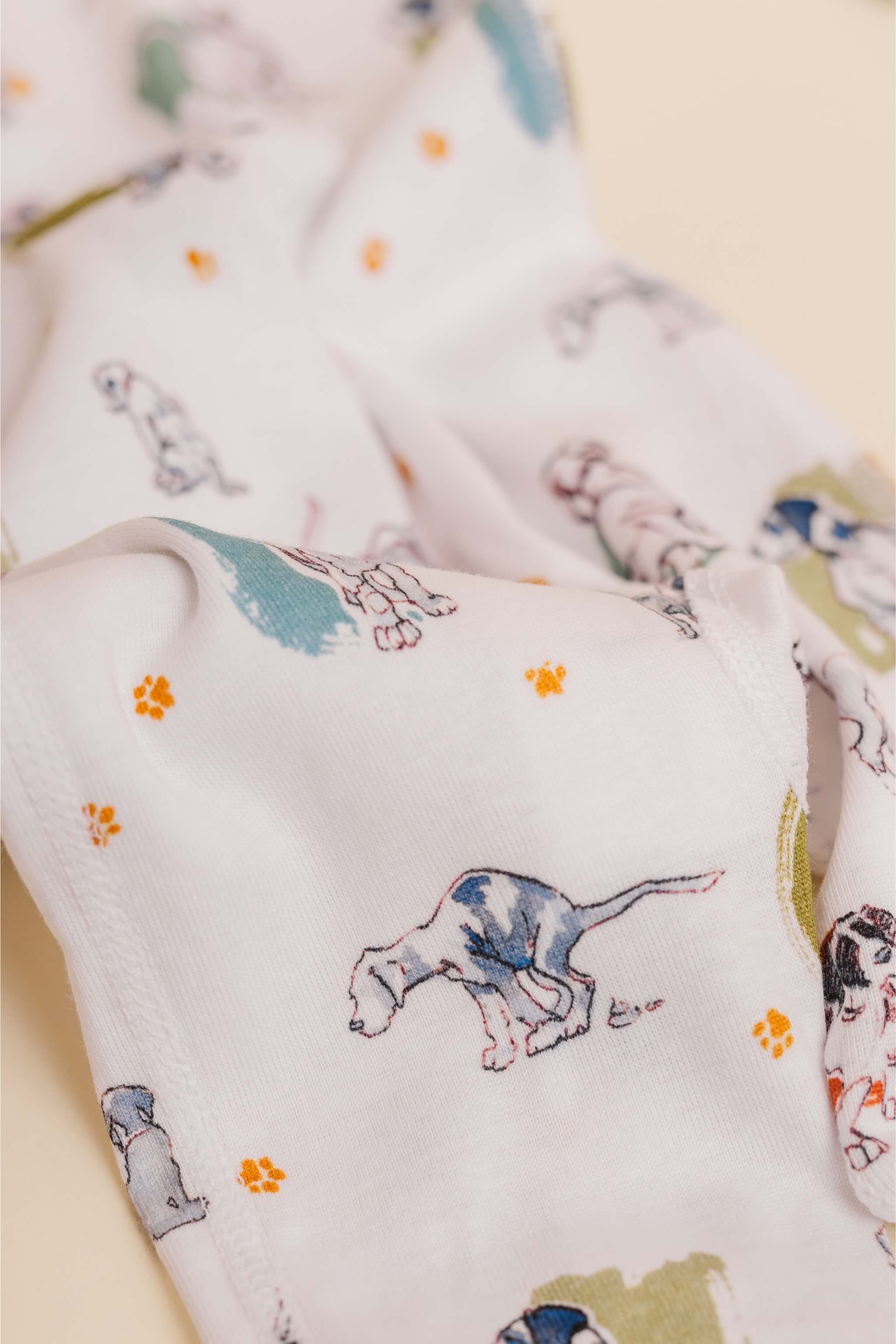 organic cotton baby zipper sleeper with fold-over cuffs in green puppy print designed by jen brandon