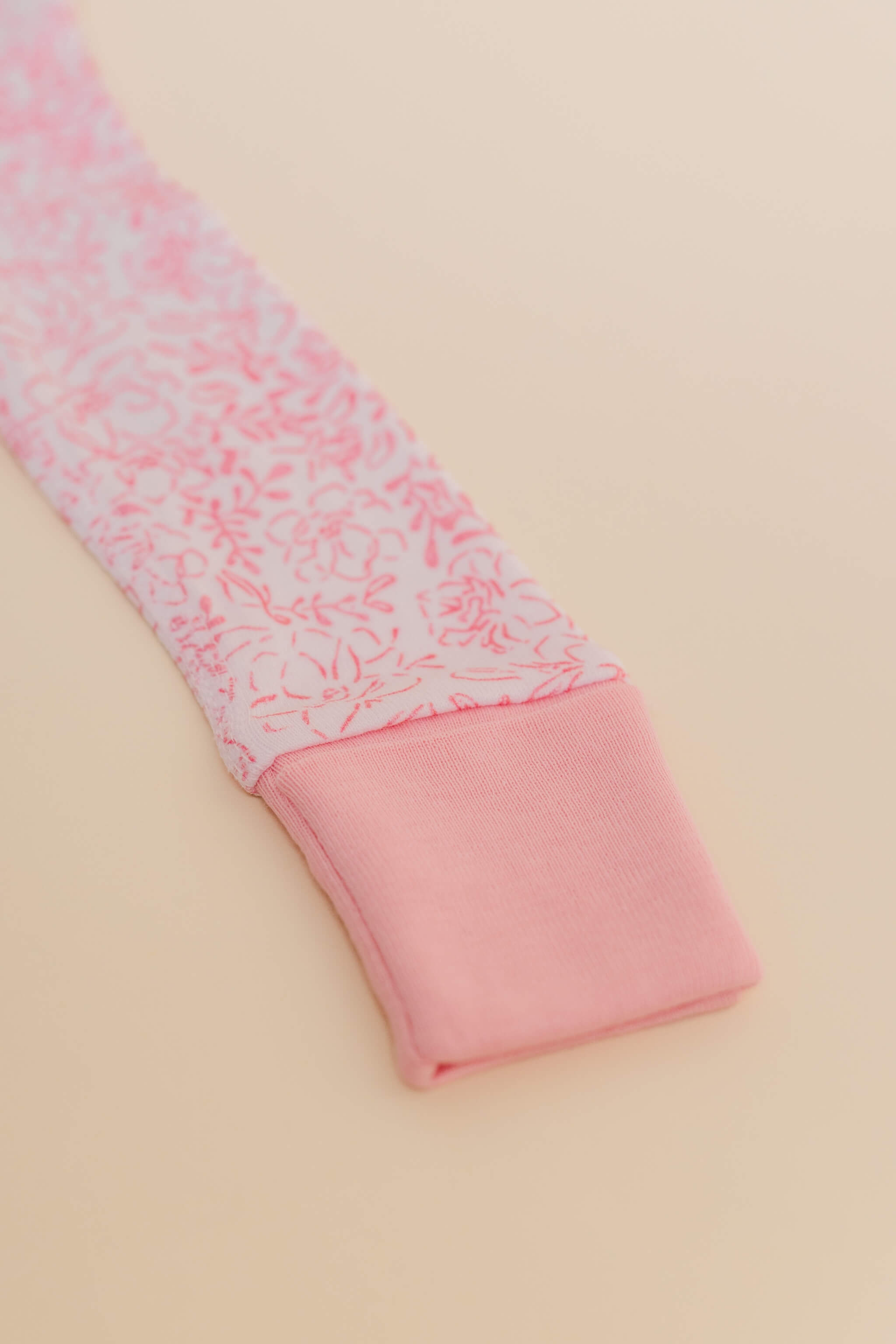 organic cotton baby zipper sleeper with fold-over cuffs in pink floral print designed by eliza baucom