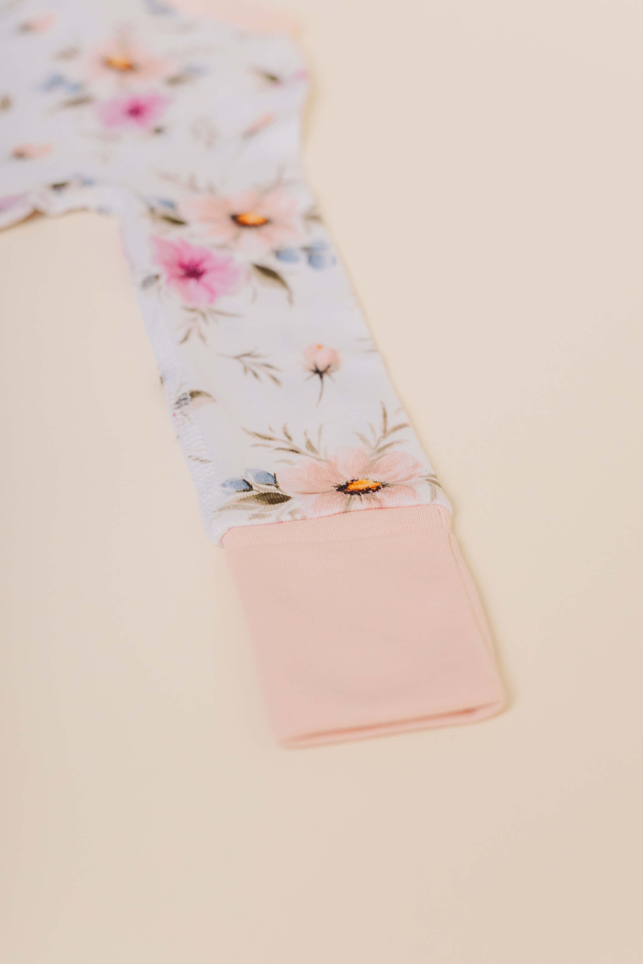 organic cotton baby zipper sleeper with fold-over cuffs in coral floral print designed by jen sweeney
