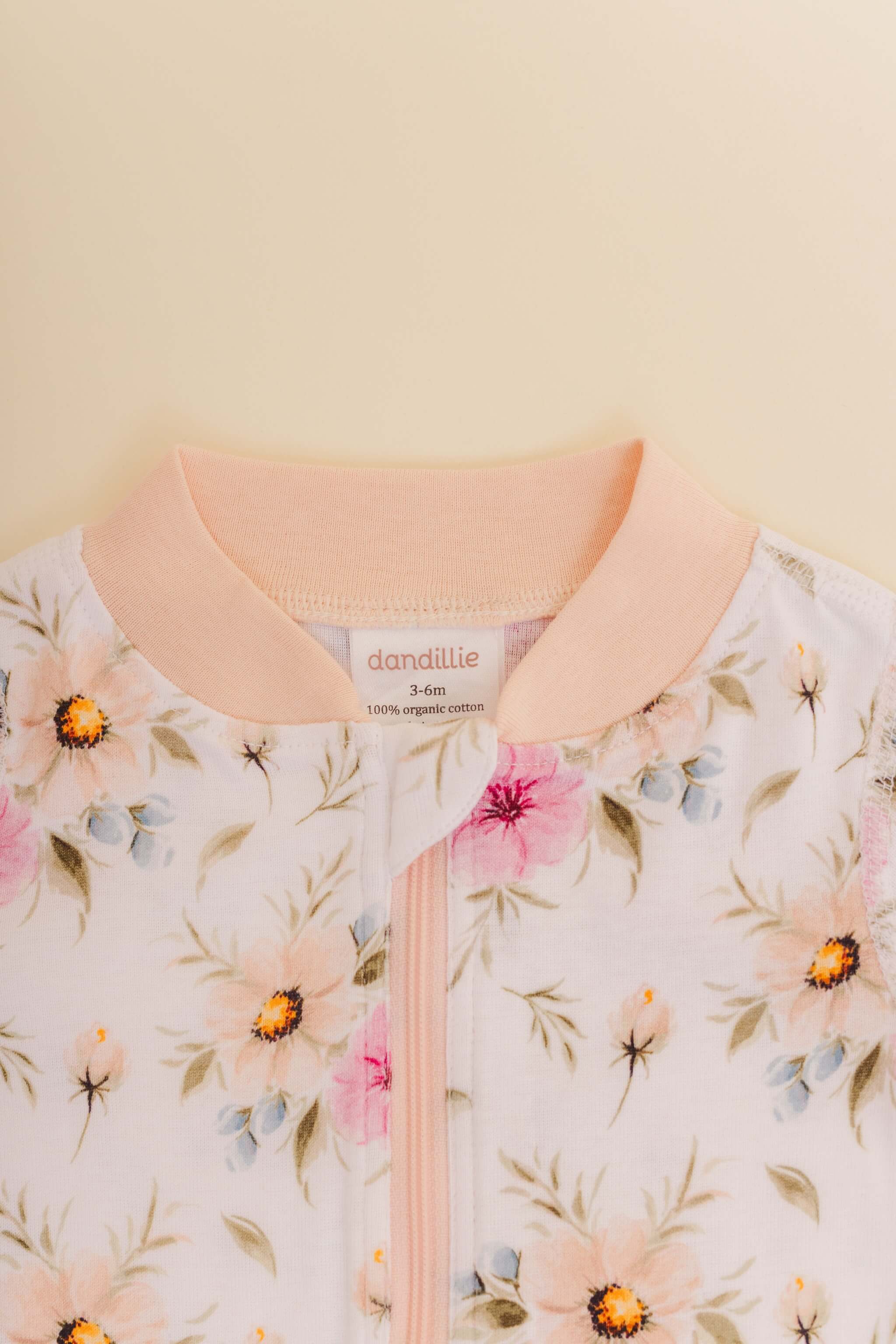 organic cotton baby zipper sleeper with fold-over cuffs in coral floral print designed by jen sweeney