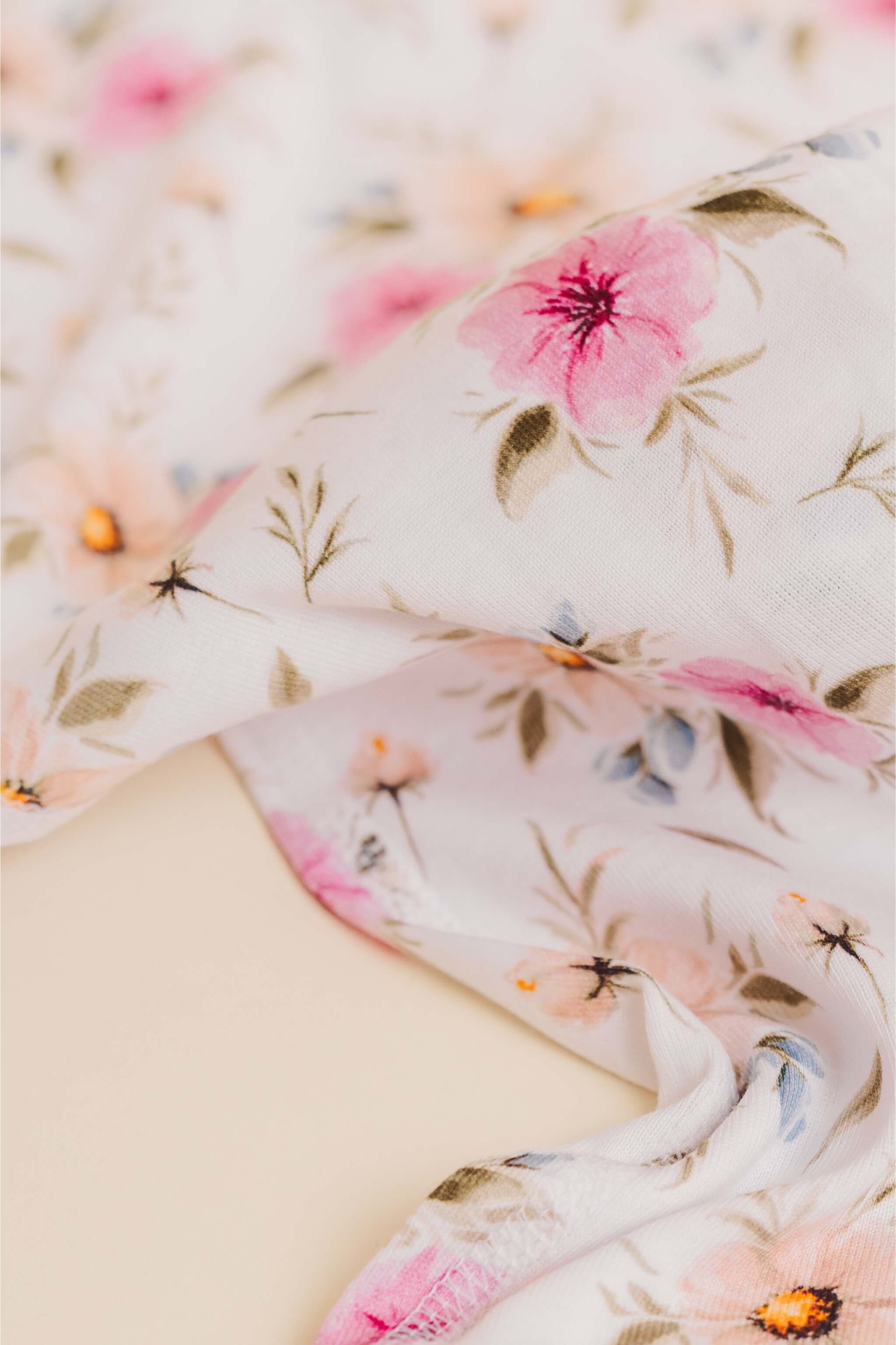 organic cotton baby zipper sleeper with fold-over cuffs in coral floral print designed by jen sweeney