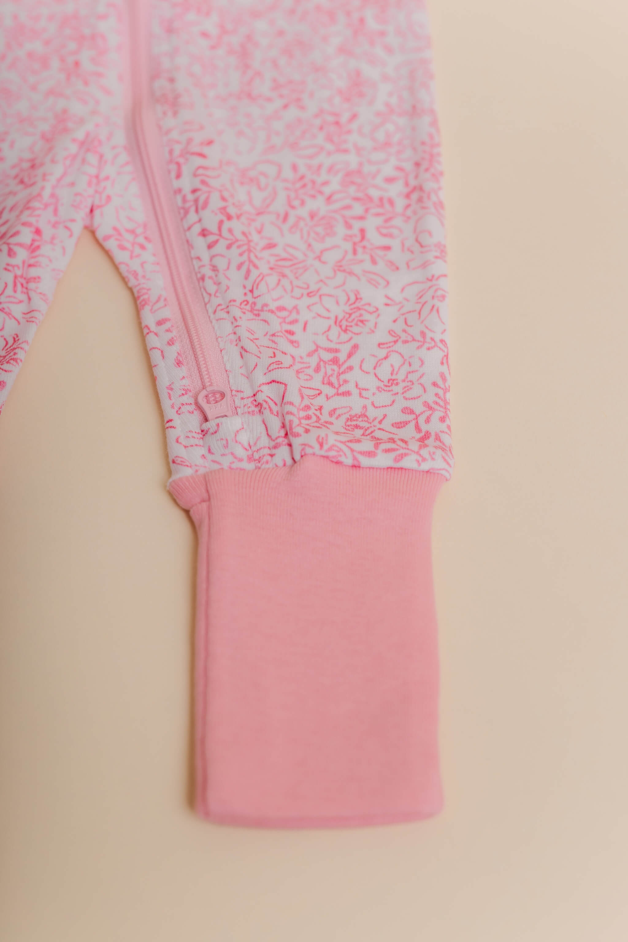 organic cotton baby zipper sleeper with fold-over cuffs in pink floral print designed by eliza baucom
