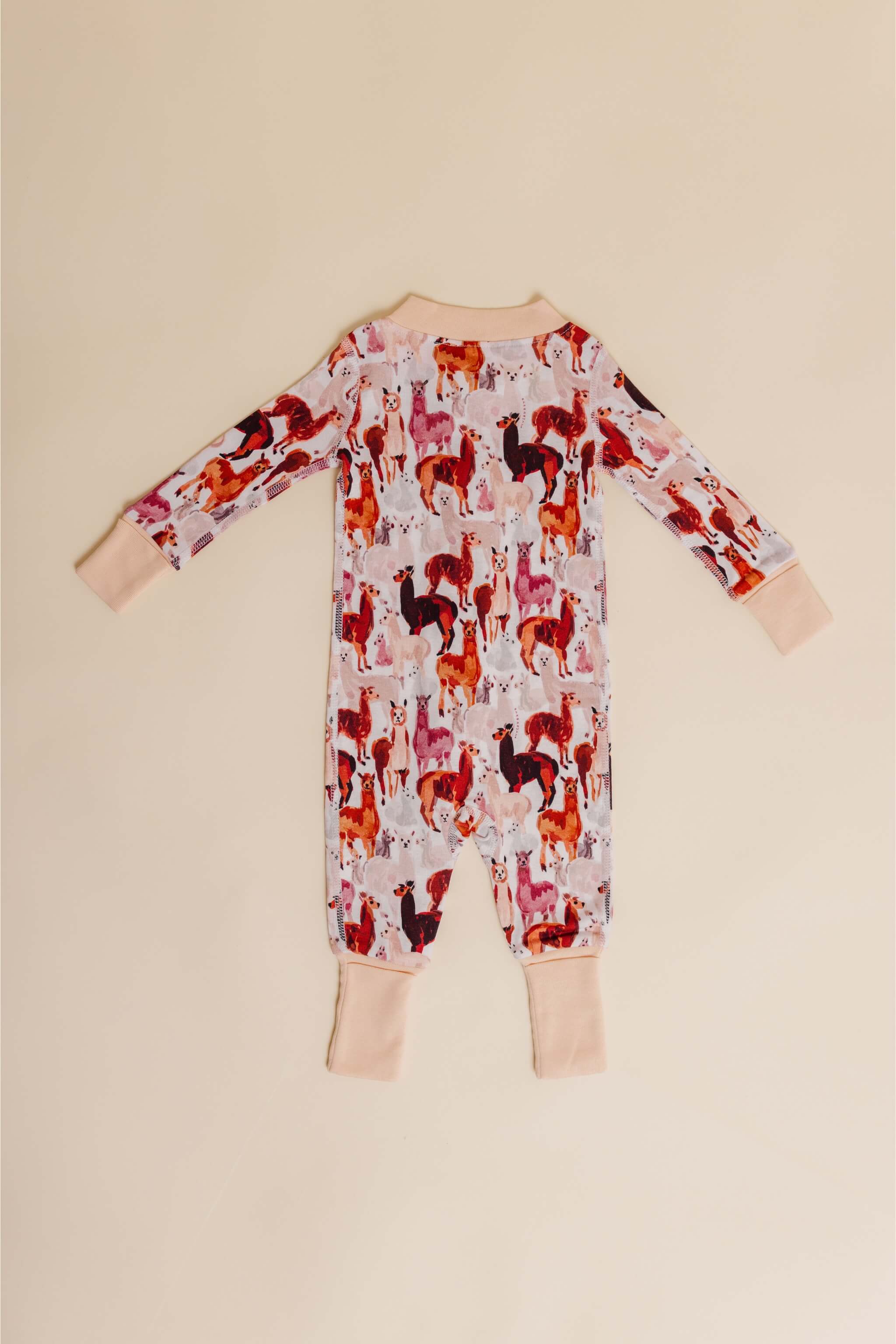 organic cotton baby zipper sleeper with fold-over cuffs in tan alpaca print designed by barbra ignatiev