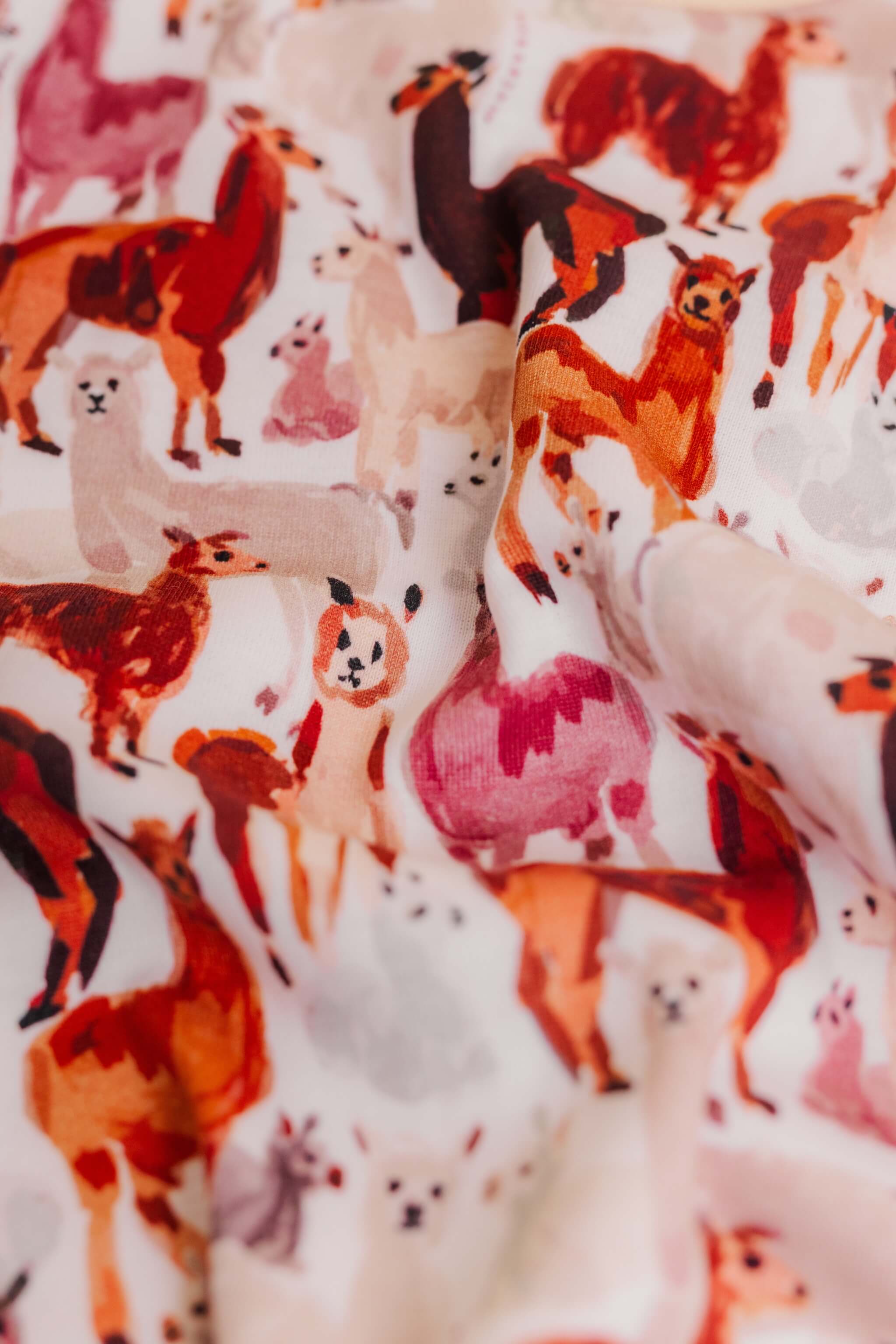 organic cotton baby zipper sleeper with fold-over cuffs in tan alpaca print designed by barbra ignatiev