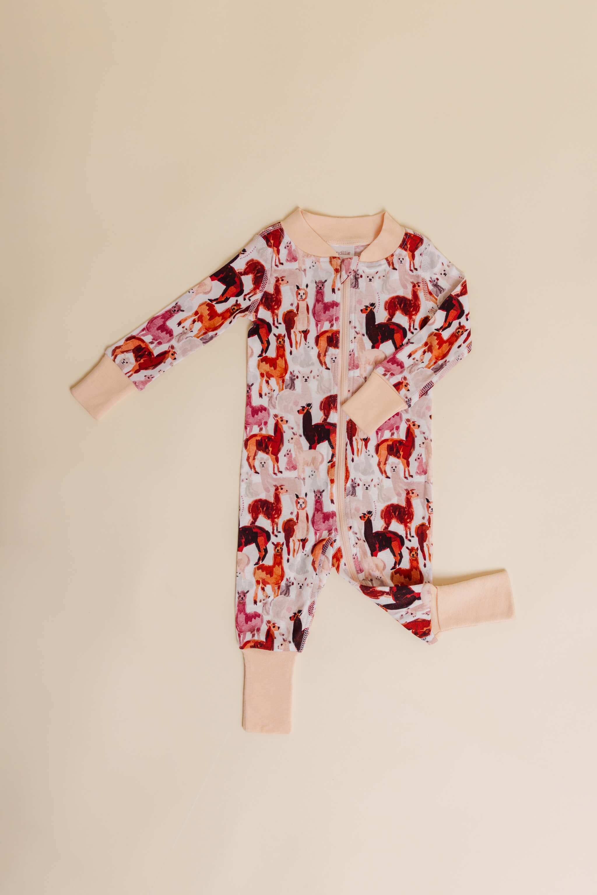 organic cotton baby zipper sleeper with fold-over cuffs in tan alpaca print designed by barbra ignatiev