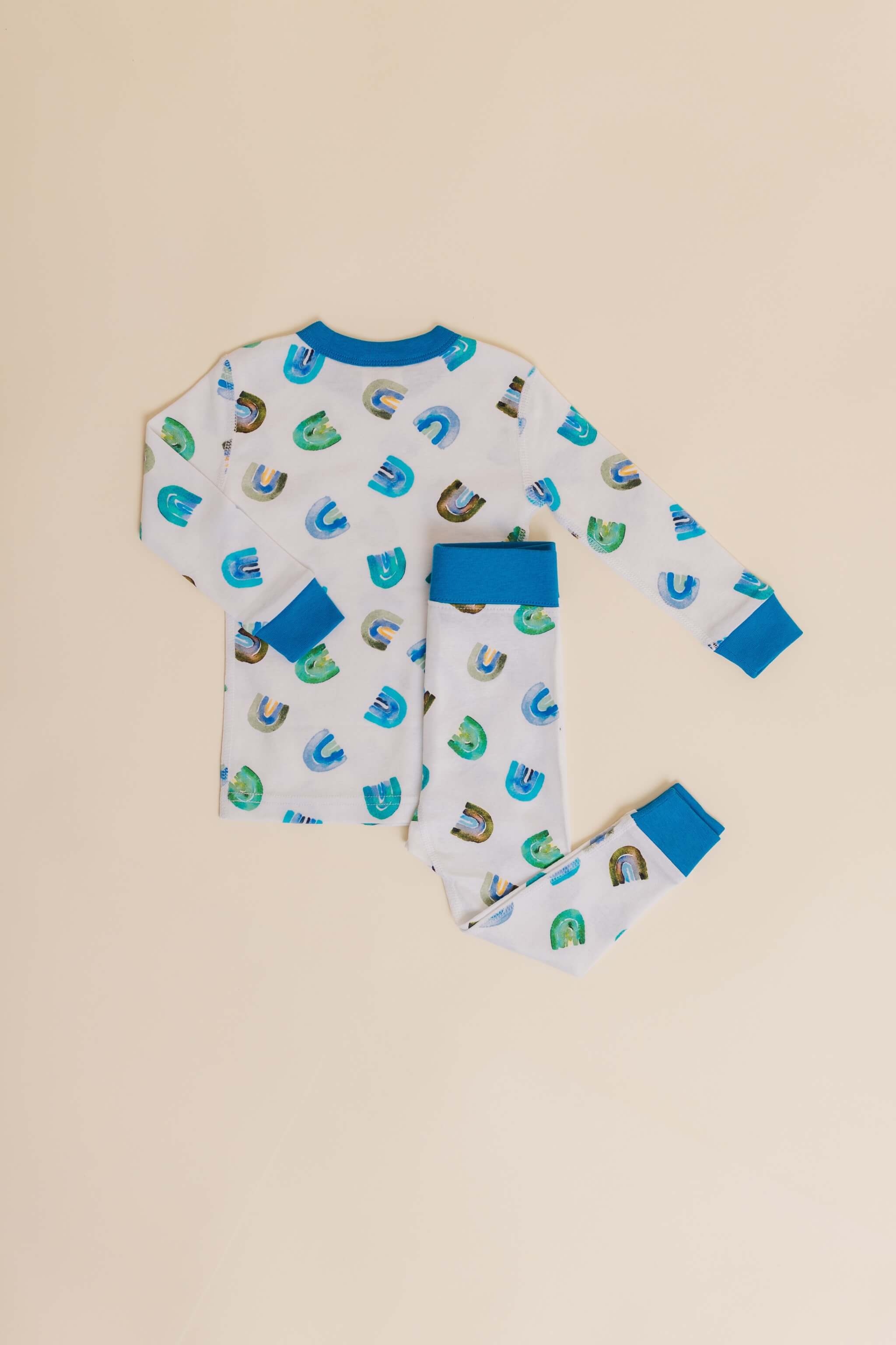 organic cotton children's long sleeve sleepwear in blue rainbow print designed by madeline kerrii