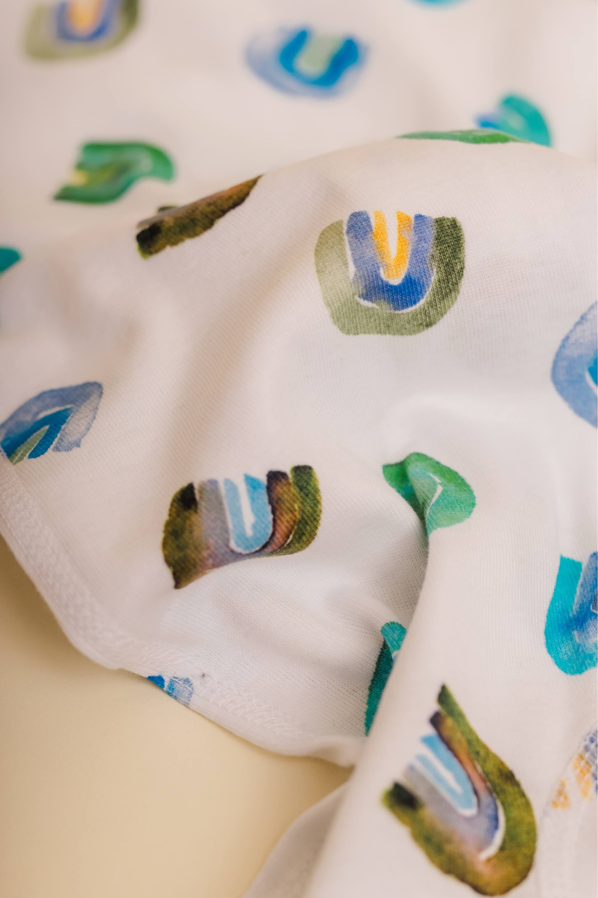 organic cotton children's long sleeve sleepwear in blue rainbow print designed by madeline kerrii