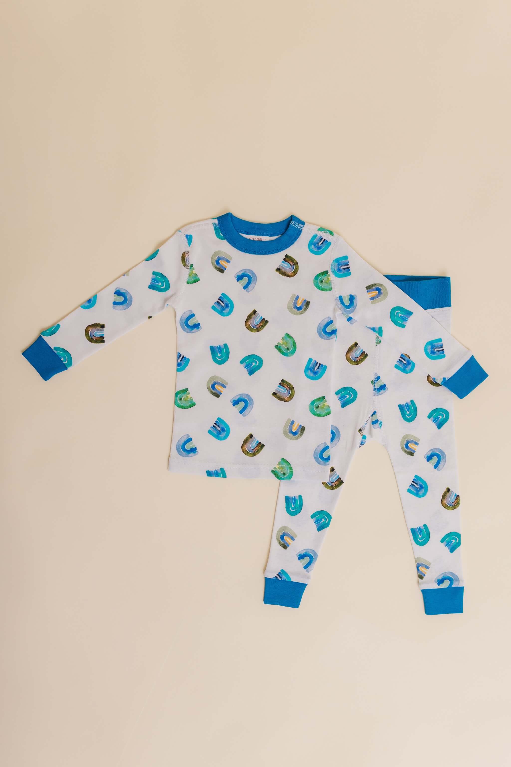 organic cotton children's long sleeve sleepwear in blue rainbow print designed by madeline kerrii