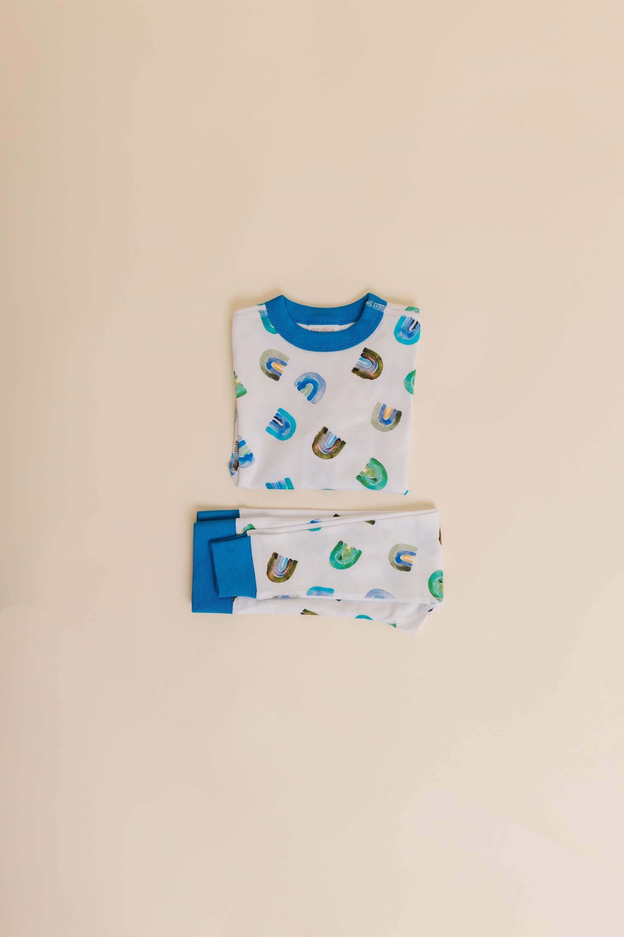 organic cotton children's long sleeve sleepwear in blue rainbow print designed by madeline kerrii