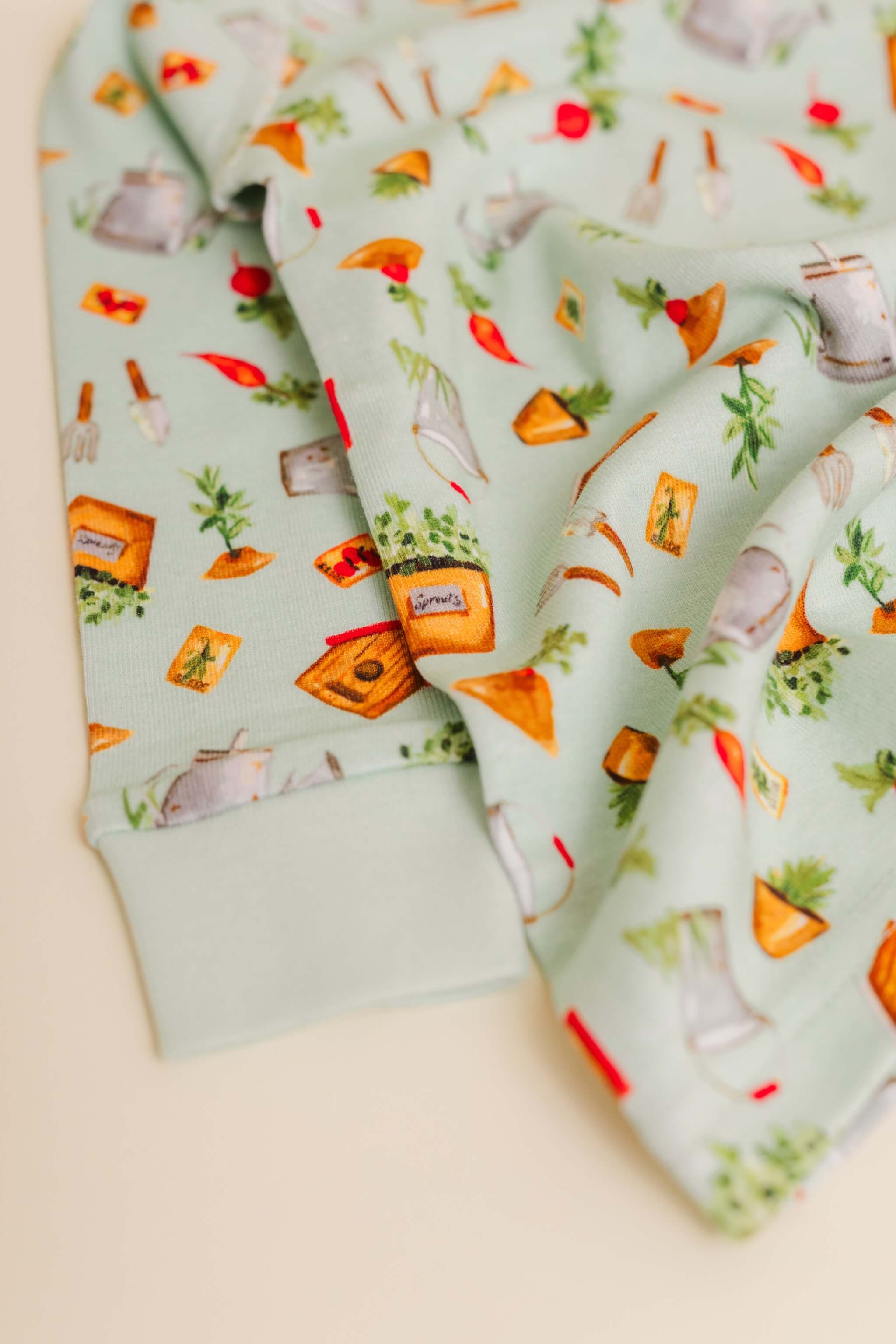 organic cotton children's long sleeve sleepwear in green garden print designed by cris rogerson