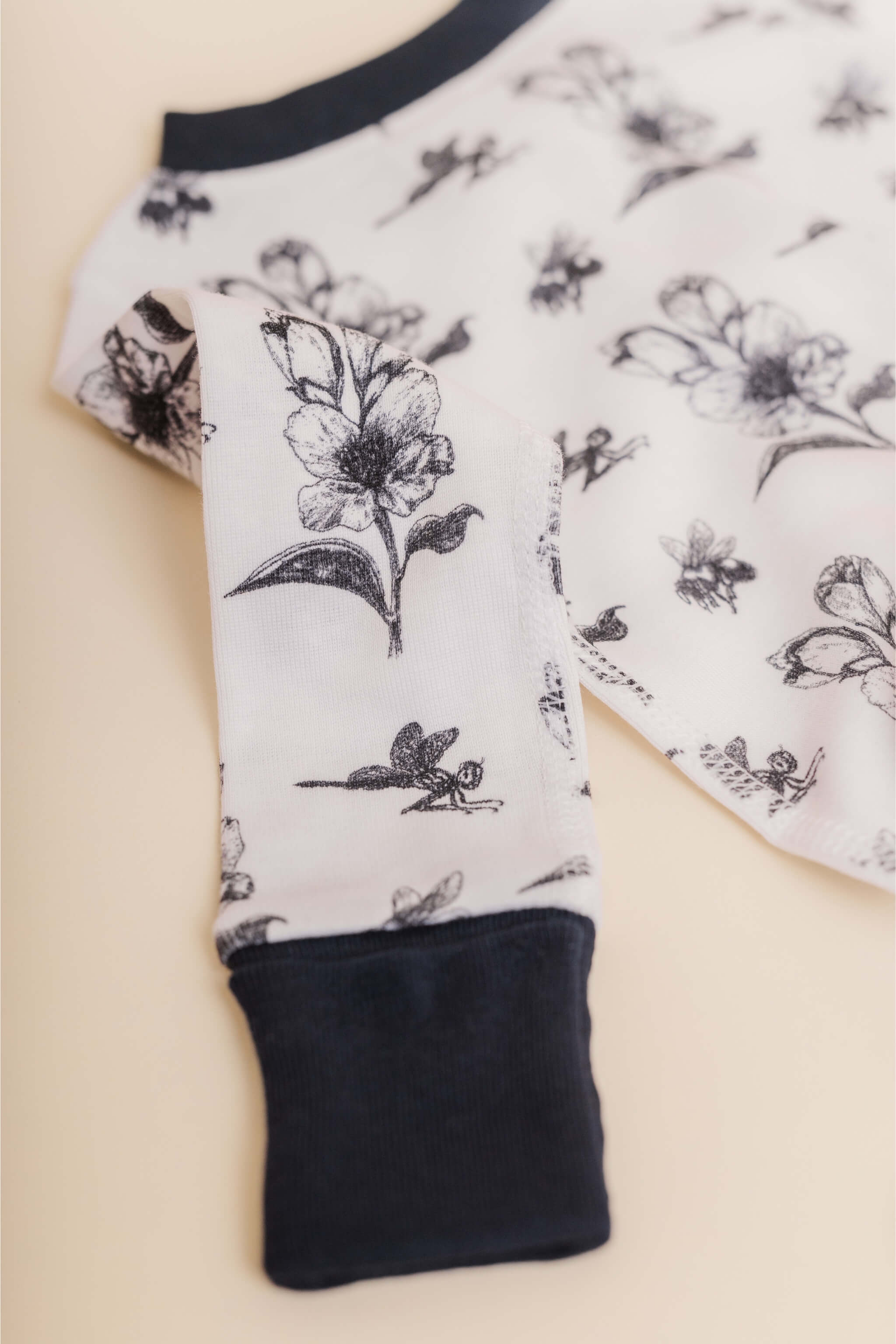 organic cotton baby zipper sleeper with fold-over cuffs in black ink print designed by chewie co