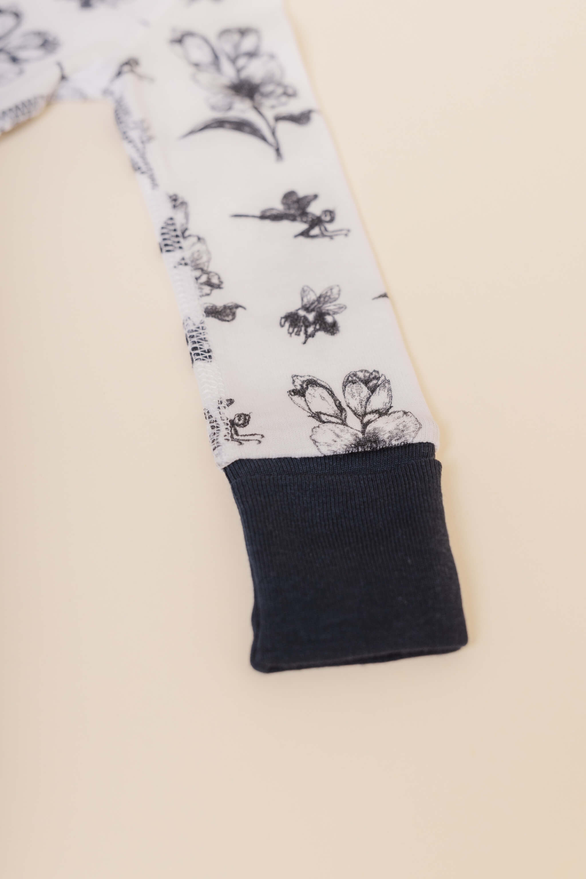 organic cotton baby zipper sleeper with fold-over cuffs in black ink print designed by chewie co