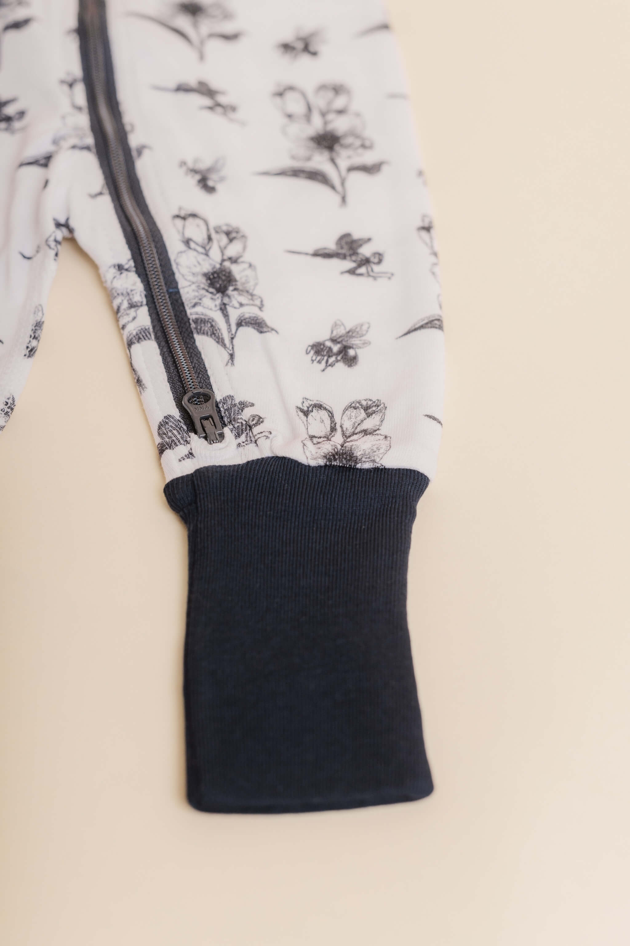 organic cotton baby zipper sleeper with fold-over cuffs in black ink print designed by chewie co