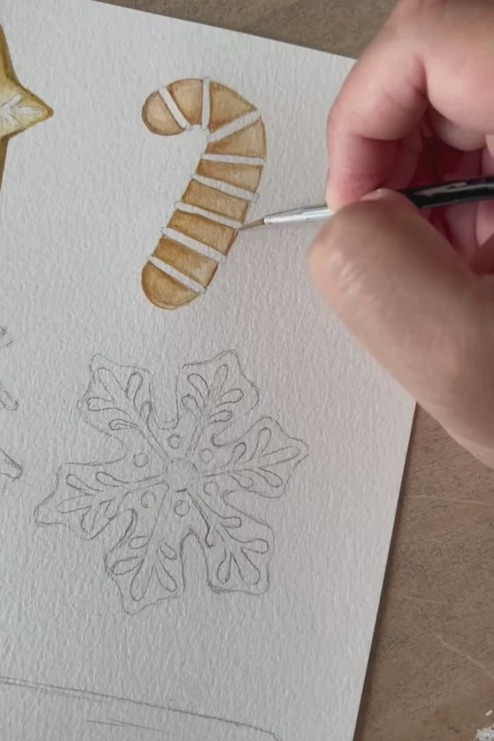 video of artist paining cookies for santa design in watercolor